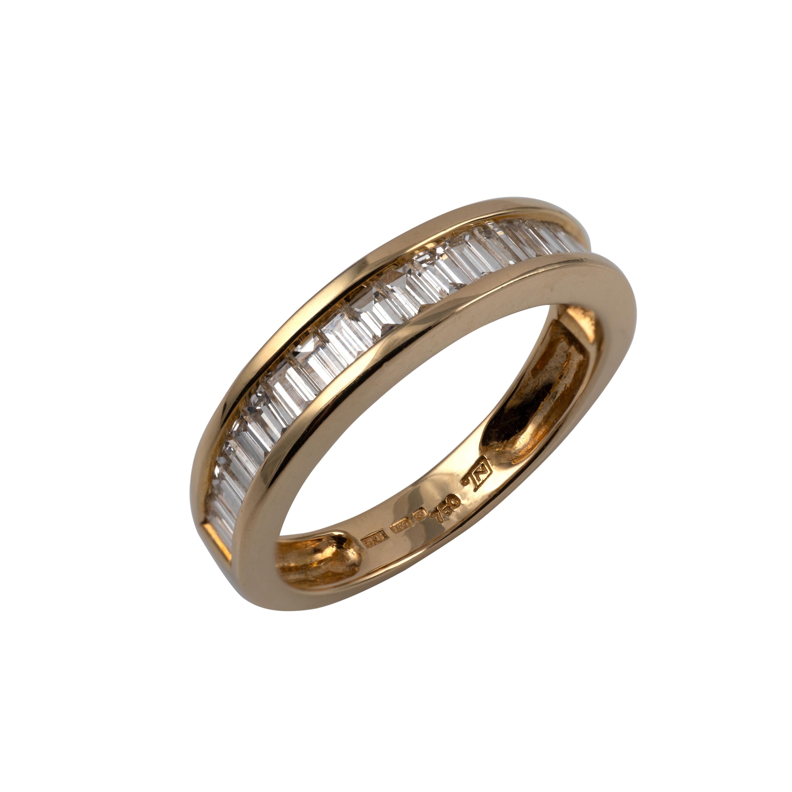 A fine quality half eternity ring crafted in 18 karat yellow gold, featuring 25 channel-set baguette-cut diamonds using high-quality VS/VVS clarity diamonds. The ring shows full UK assay hallmarks and is presented in excellent condition. It comes