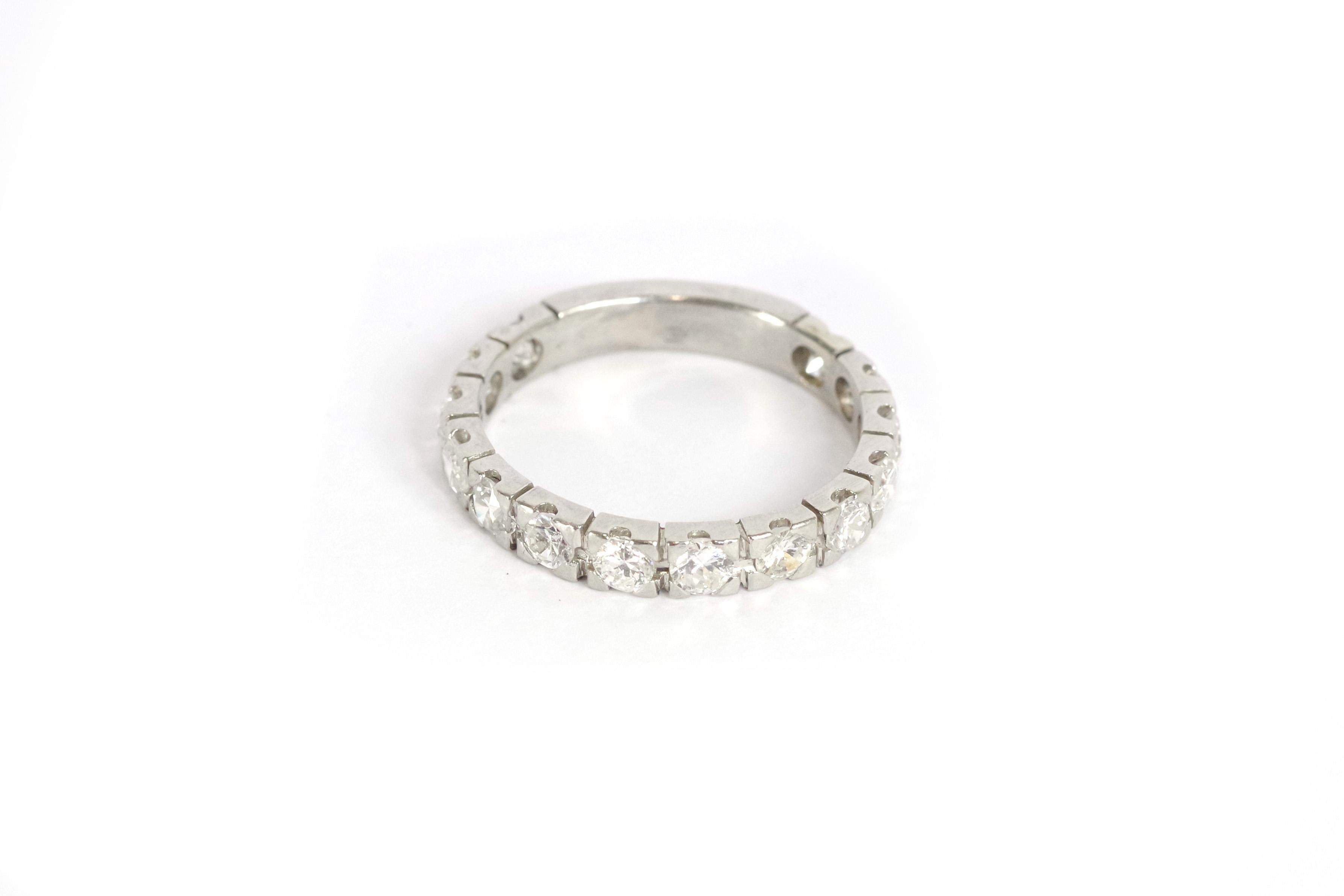 Half eternity ring band in platinum and diamonds. American half wedding band set with 14 brilliant-cut diamonds on a gray platinum setting. Antique wedding band from the early 20th century. 

Dog-head hallmark (french state hallmark for