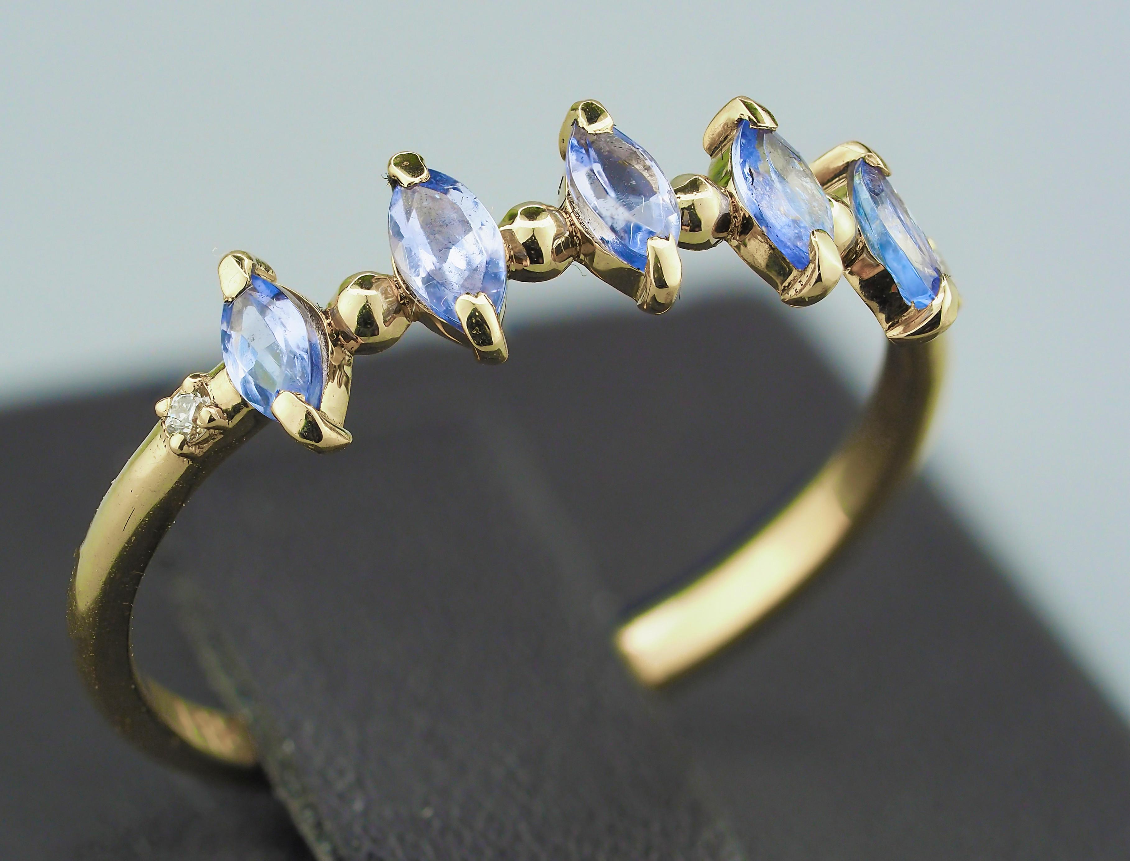 Half eternity tanzanite ring in 14k gold. 
Marquise tanzanites ring. Delicate tanzanite ring. Semi eternity tanzanite ring.

Metal: 14k gold
Weight: 1.3 g. depends from size.

Set with tanzanites
Marquise shape, light violetish blue color, aprx 1 ct