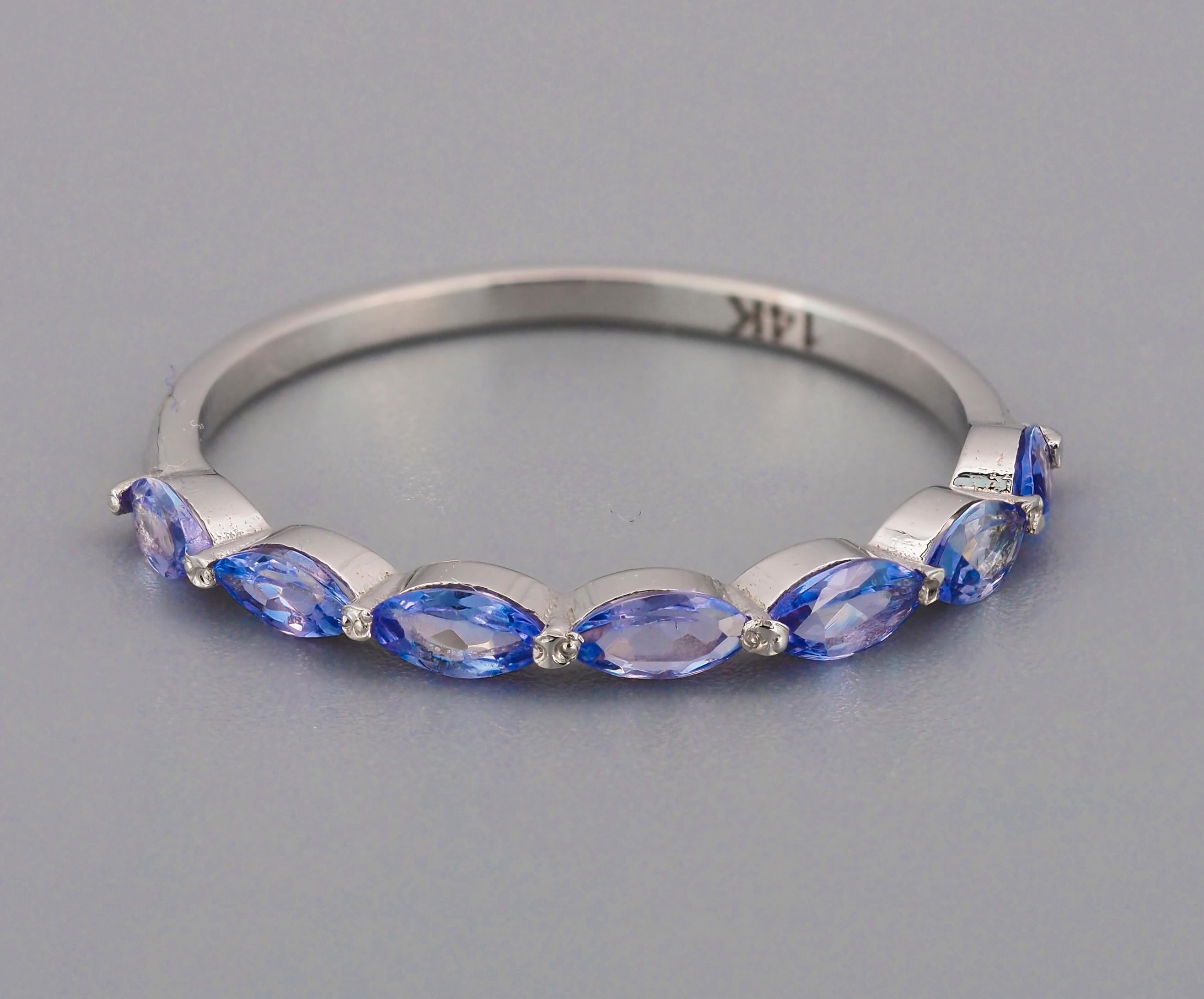 Half eternity tanzanite ring in 14k gold. 
Marquise tanzanites ring. Delicate tanzanite ring. Semi eternity tanzanite ring.

Metal: 14k gold
Weight: 1.3 g. depends from size.

Set with tanzanites
Marquise shape, light violetish blue color, aprx 1.00