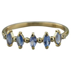 Half eternity tanzanite ring in 14k gold. 