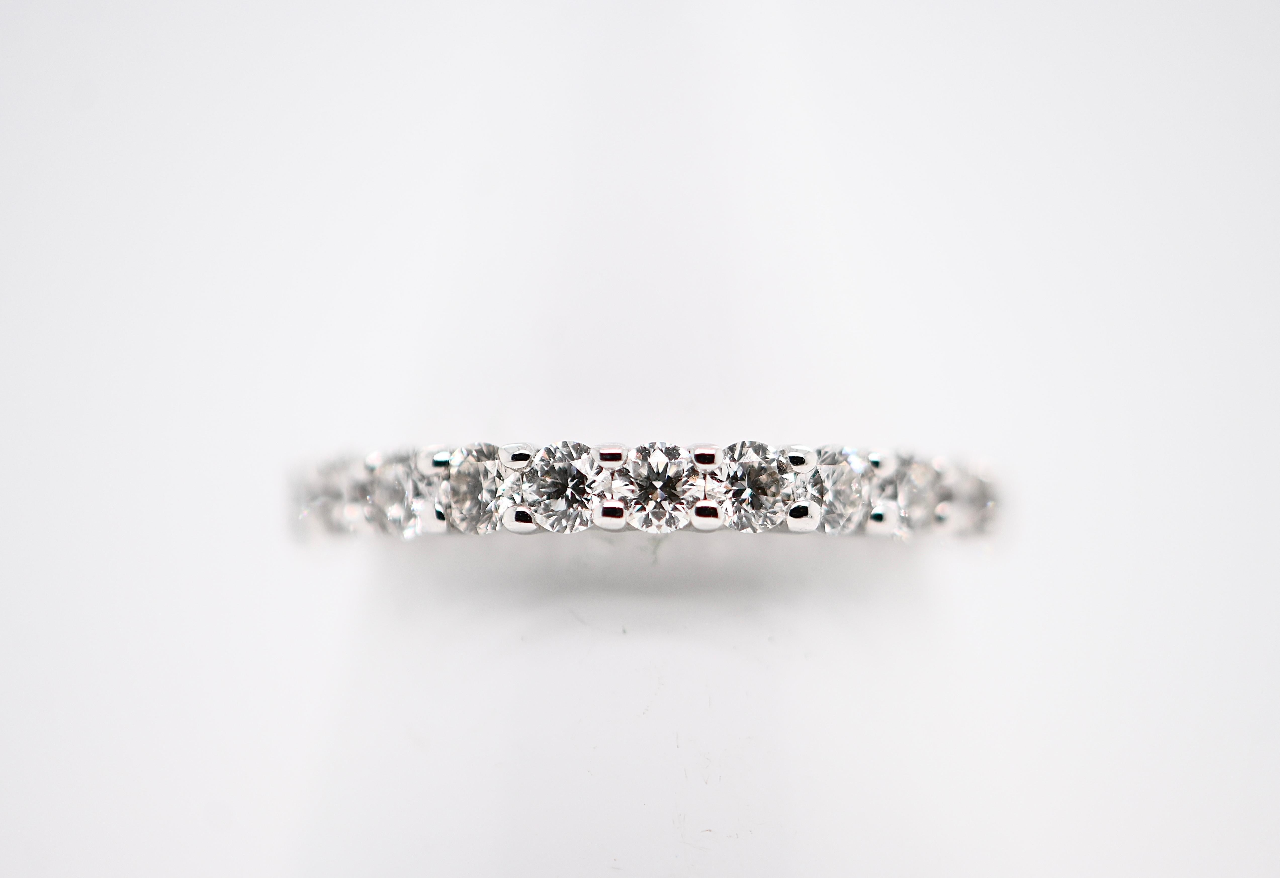 Indulge in timeless elegance with our Half-Eternity Wedding Band, meticulously crafted from 18 carat white gold. This exquisite piece features twelve brilliant-cut diamonds, totaling 0.860 carats and boasting a stunning F color grade, ensuring