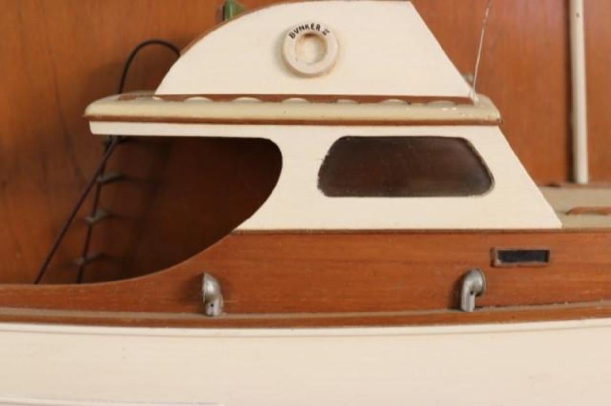Nicely executed model of the yacht Bunker II, once owned by Henry H. Egly. The model has exceptional detail with varnished cabins, flying bridge, turn screw, etc. With copper nameplate decorated with crossed burgees. Mounted to a wood board with