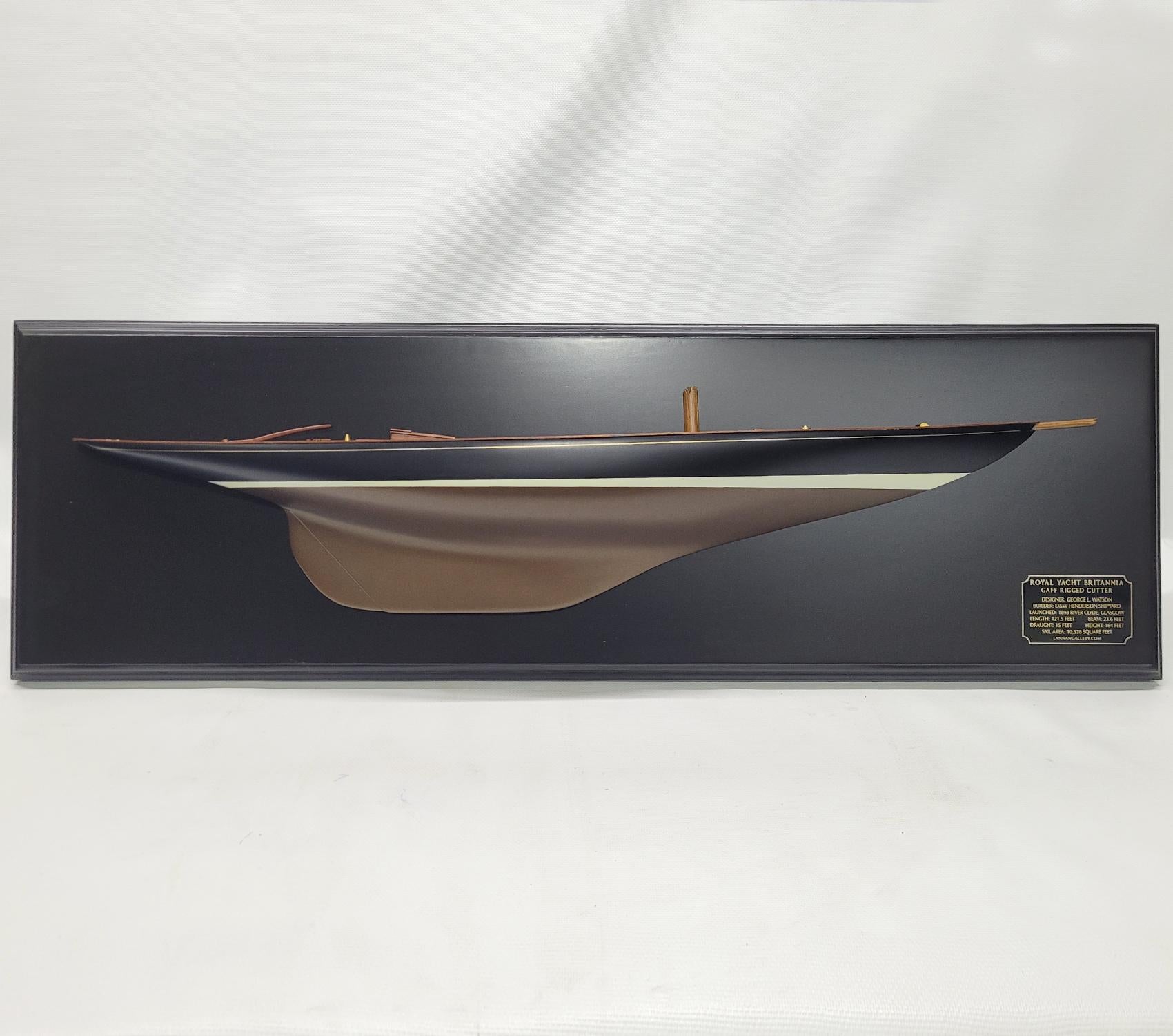 Scale half model of the British Royal racing yacht “Britannia”. Large model with hull painted black over bronze. Planked deck with skylights, tiller, companion ways, stubbed mast, anchor, bowsprit etc. There are six mahogany skylights all fitted
