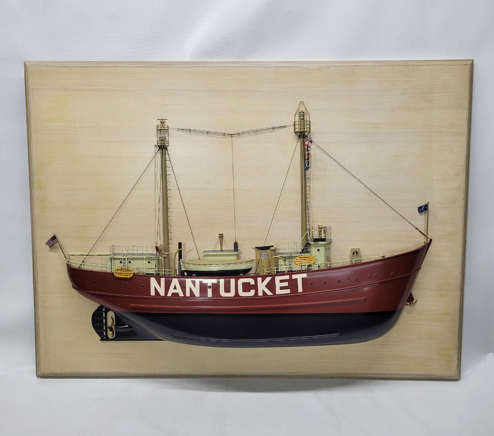 Museum quality half model of the Lightship Nantucket. This fine model has a carved hull, countless milled brass fittings, built up cabins, etc. Details include masts with signal flags, railings, lifeboat, stove pipe, bell, winch, funnel, etc.