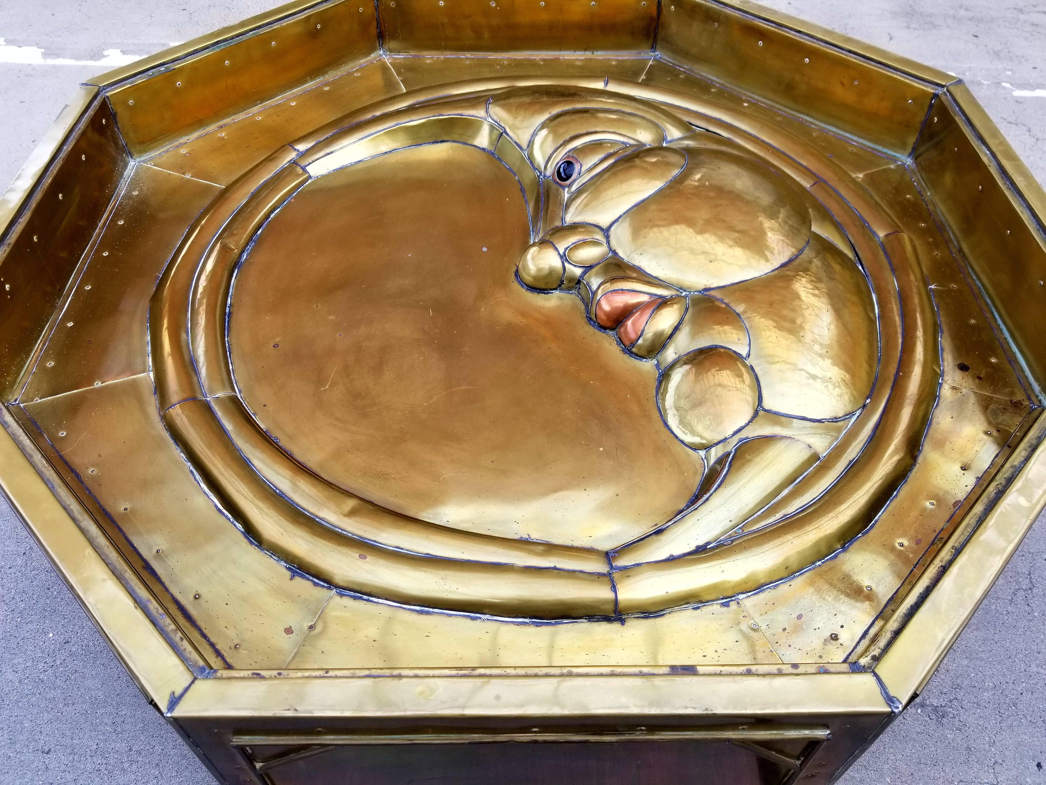 A brass octagonal coffee table by Mexican artist Sergio Bustamante. Depicting a classic half moon detail. Deep relief in solid brass plates. Known for table sculptures in both porcelain and metal. Coffee tables are rarely found.