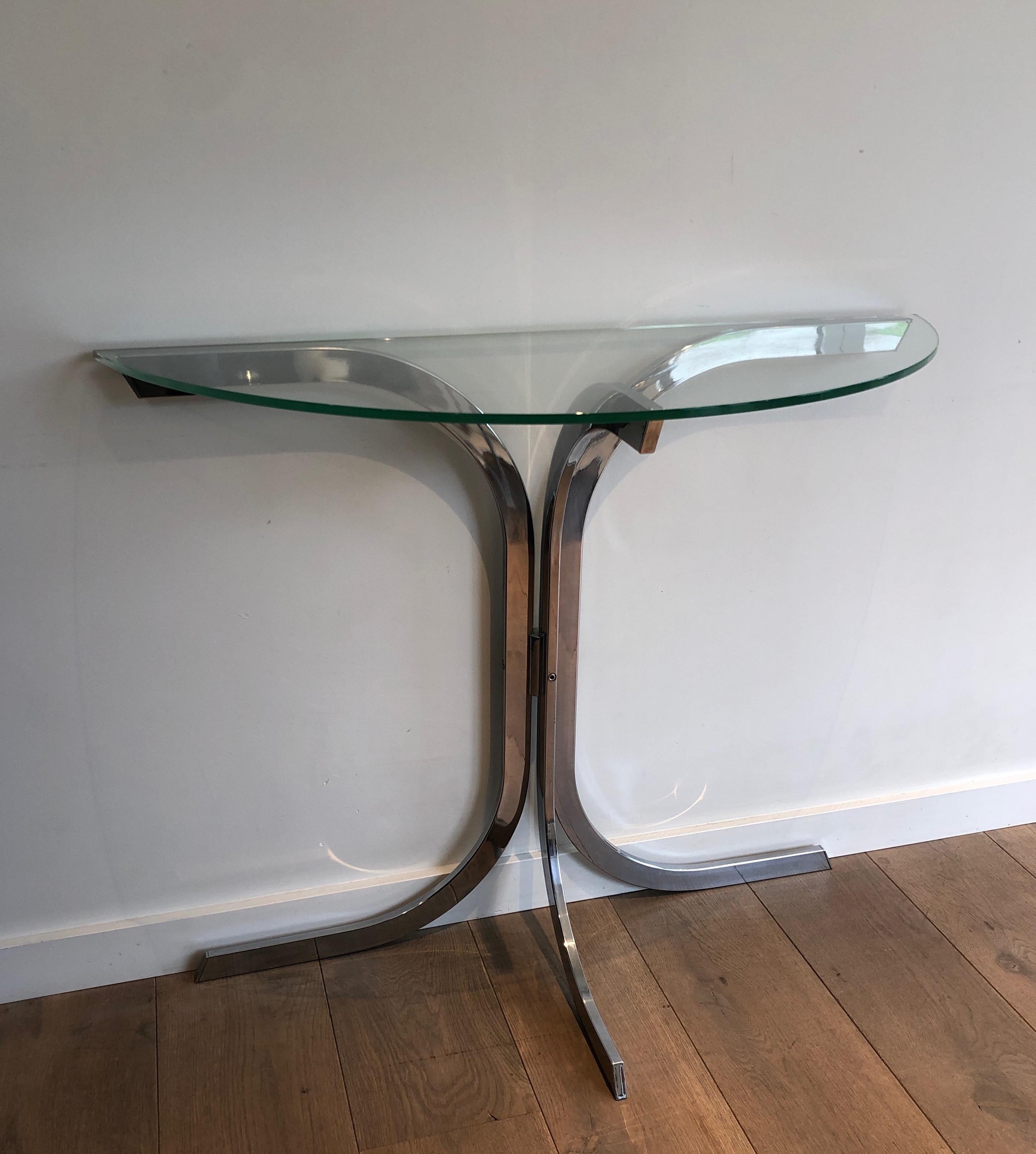 This half-moon console table is made of chrome with a nice rounded glass piece on top. This is a French work in the Style of Maison Charles. Circa 1970