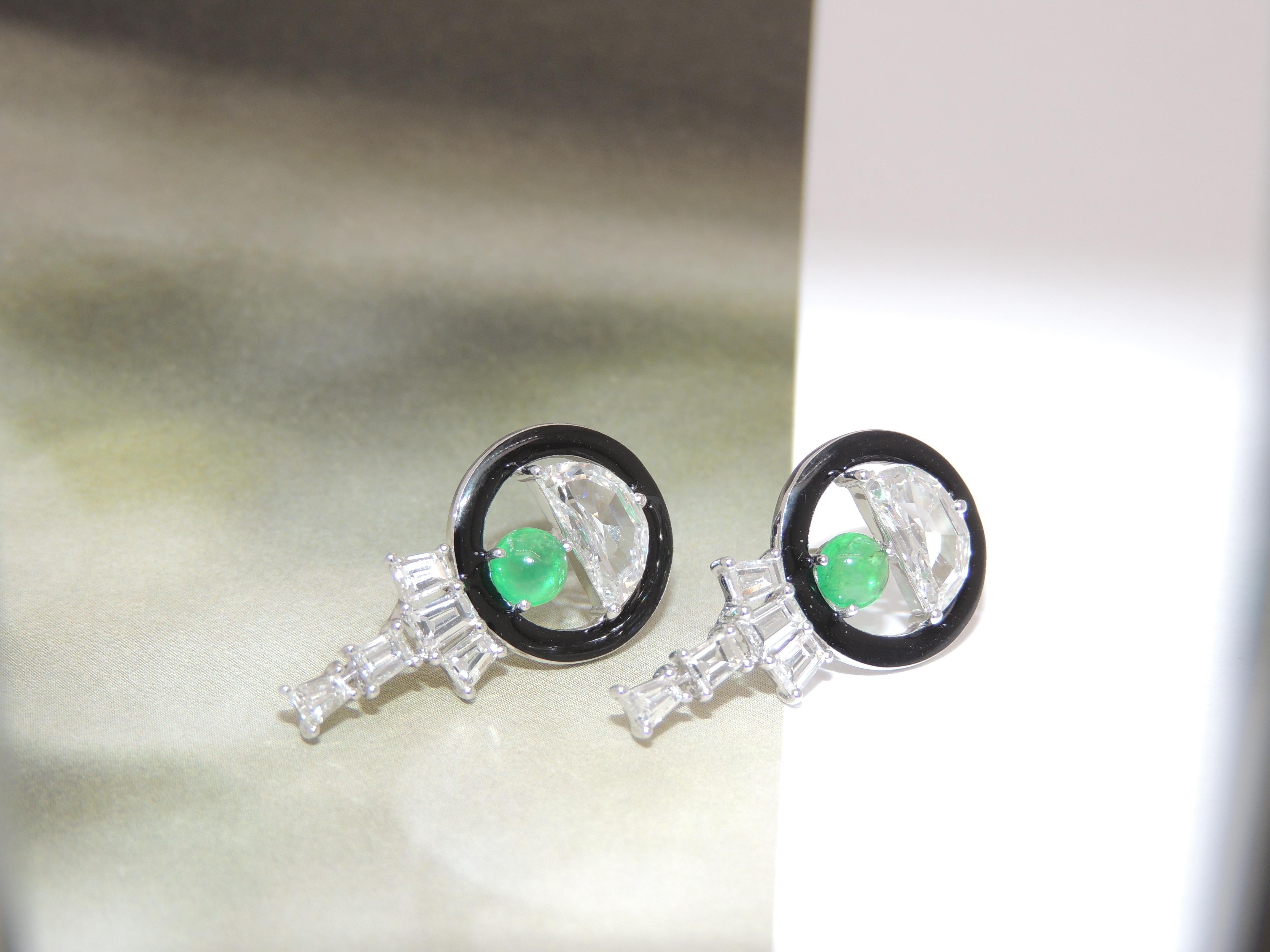 Magnificent half-moon diamonds sit pretty at the top of these earrings, with black enamel, diamond baguettes and emerald cabochons completing the piece.

Inspired by themes such as geometric design and vibrant colours from the Art Deco Period of the