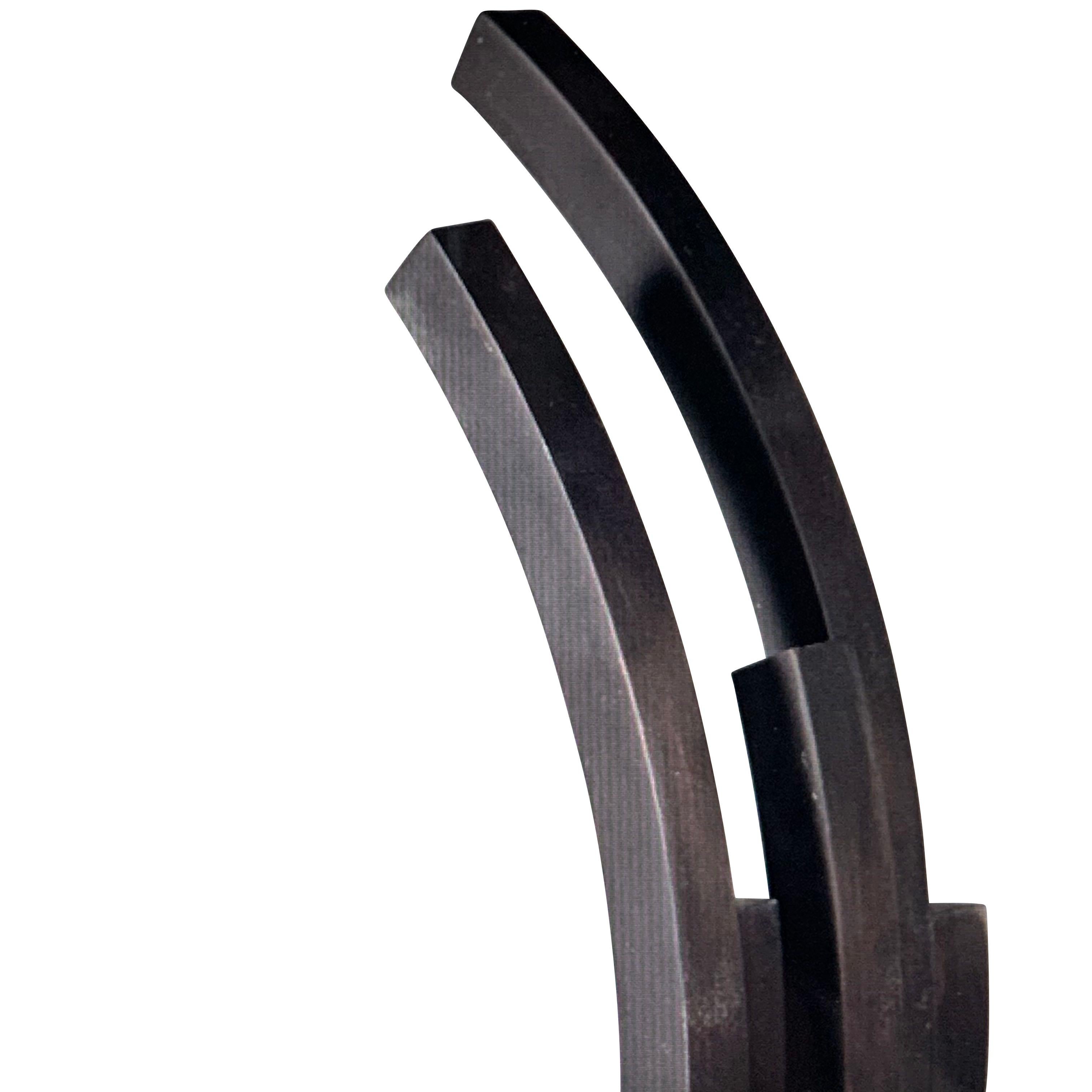 Contemporary iron sculpture in half moon shape
Five bands in varying sizes.
  