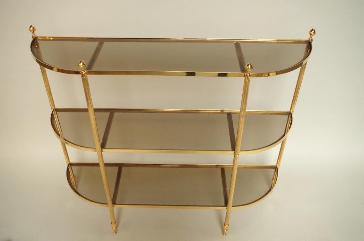 Gilt brass Louis XVI style console with three smoked glasses.
Made in circa 1970.