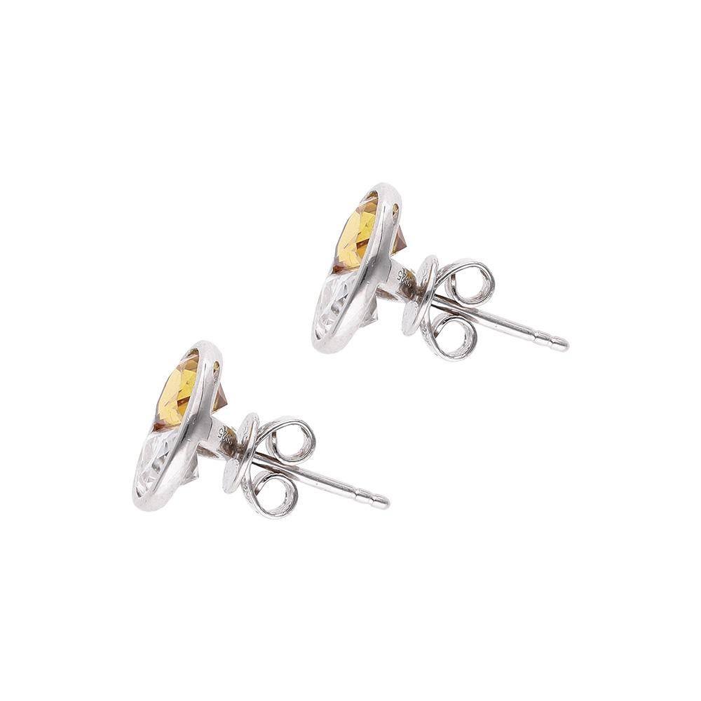 These studs feature two rare, half moon cut orange sapphires and moissanite in a tension setting. The contrasting colours allude to the yin yang, the ancient symbol of harmony and balance. This pair of studs shine brightly, just like the sun rising