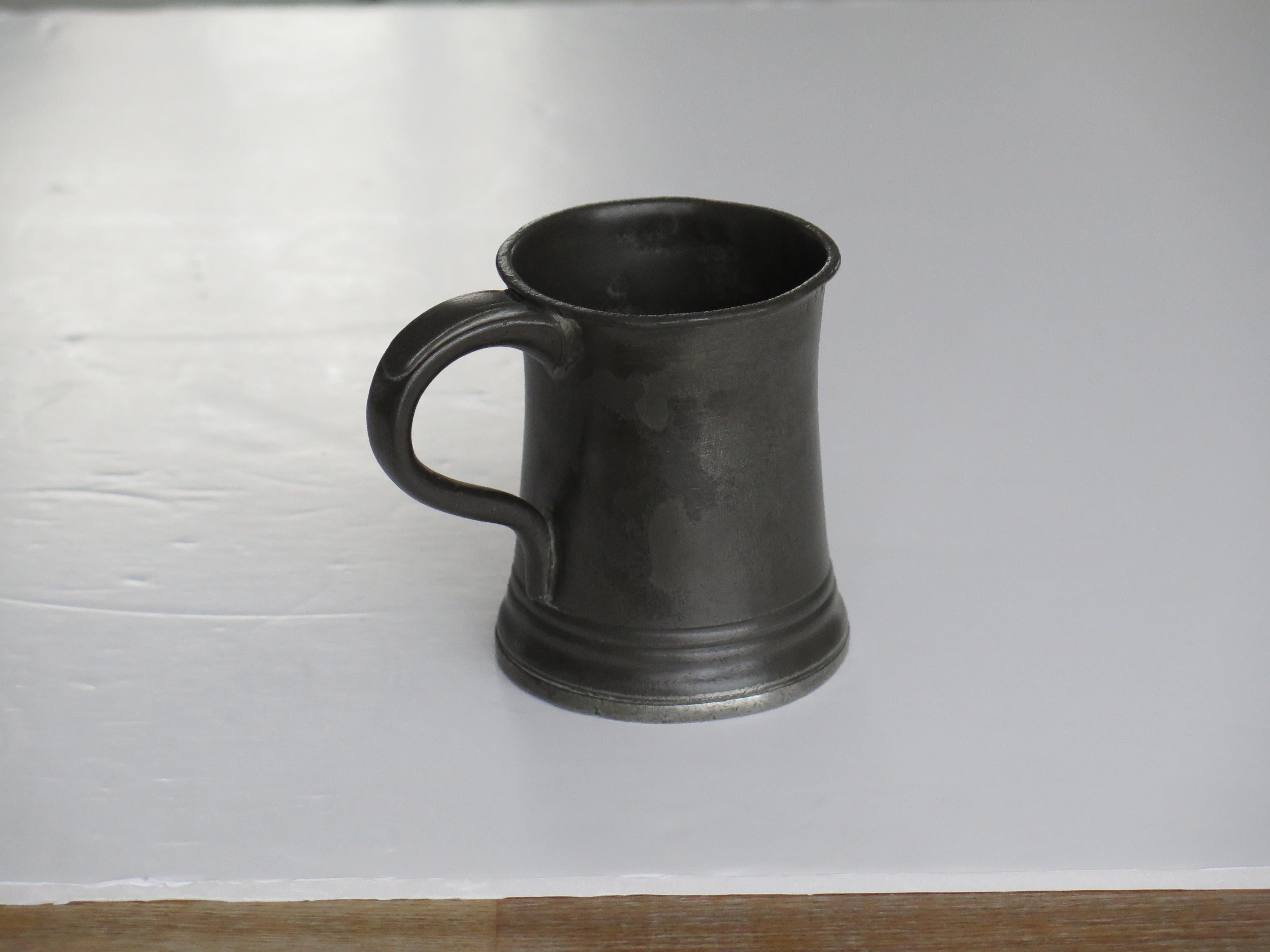 This is a good mid-19th century pewter half pint tankard or mug all fully stamped and with the makers name of James Yates

This tankard has a good shape with a flared skirt base, curved over top rim and a solid loop handle with a thumb rest to the
