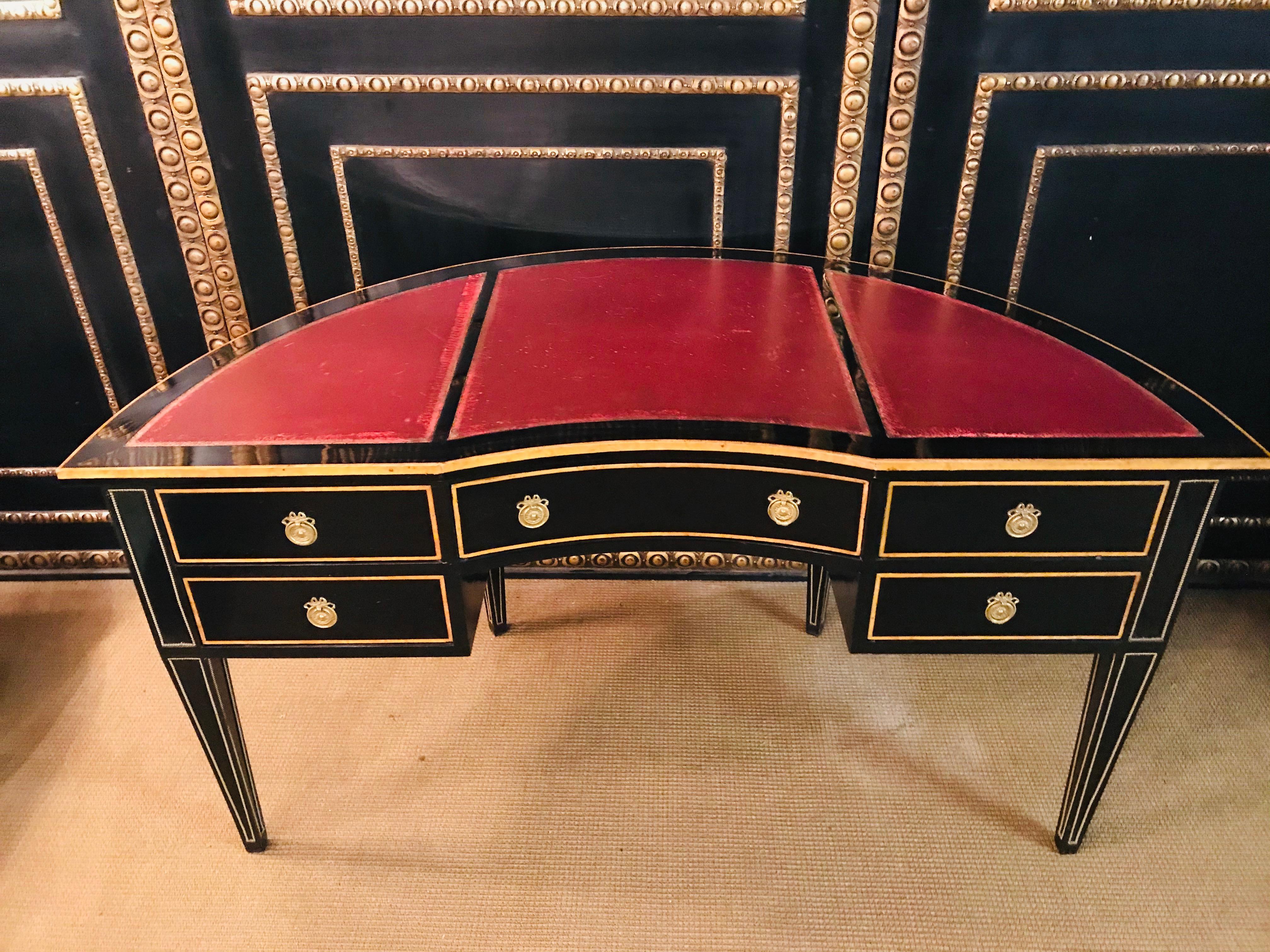 Fancy desk in the Biedermeier style

Piano black polished veneer on solid softwood. Semi-oval body, five drawers on four conical legs, slightly protruding, profiled writing surface, in the middle, inlaid, gold-embossed leather.
This is leather is