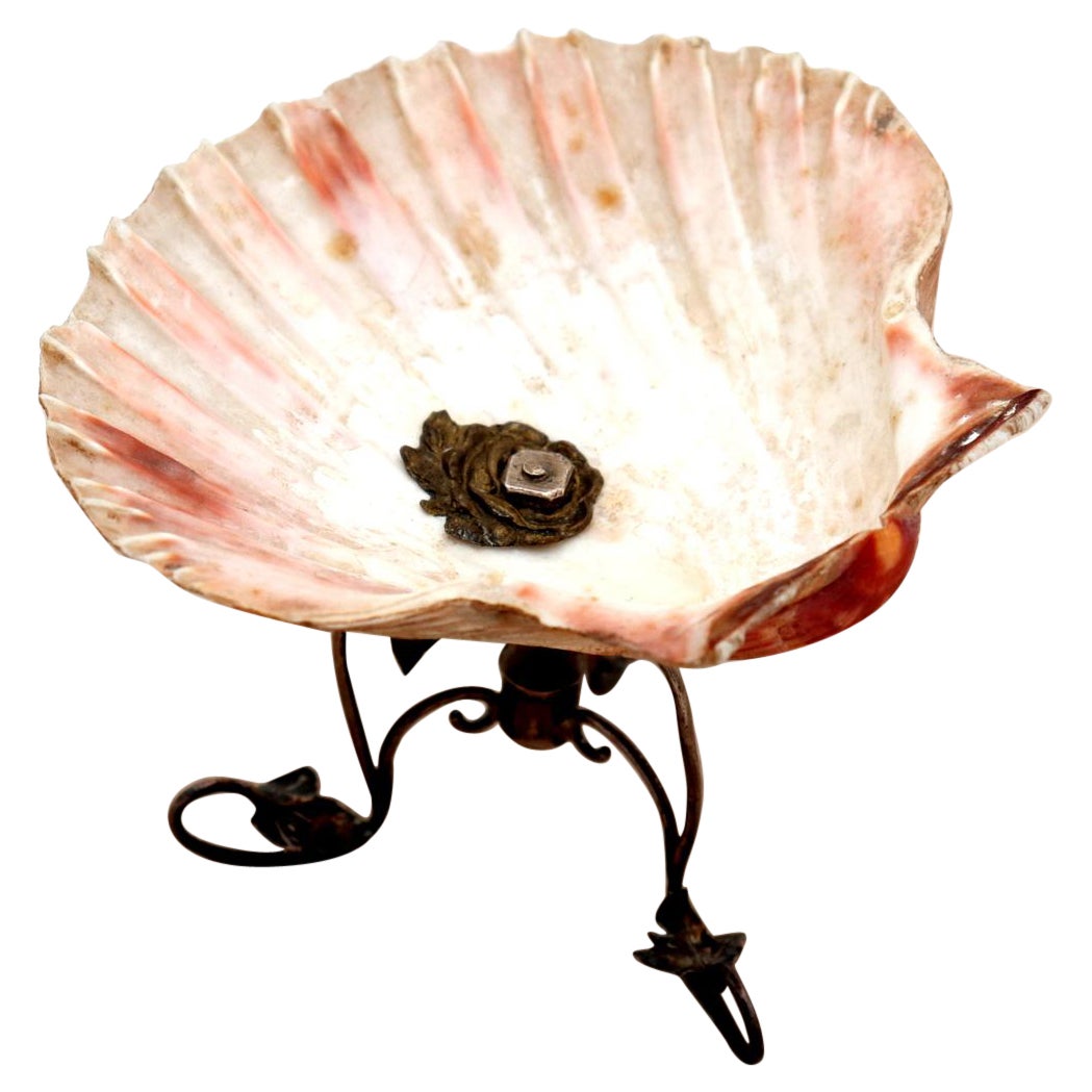 Half-shell shaped ashtray with silver frame