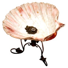 Half-shell shaped ashtray with silver frame