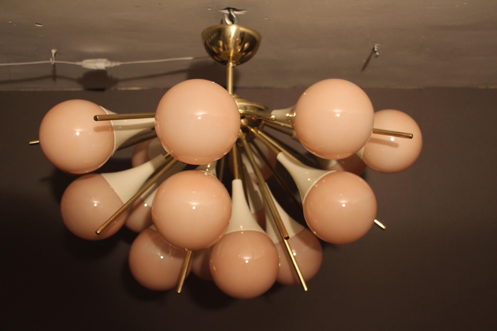 This fabulous chandelier features 18 pinkish-beige handmade Murano glass globes and brass stems.
It looks like large flowers and is really breath taking.
When light is on, its very light pink-beige globes turn to beige color.
All globes are not