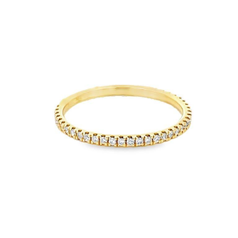 Introducing our Half-Way Diamond Band in 18K Yellow Gold! This stunning piece features round white diamonds with a total of 0.15 carats. The diamonds radiate brilliance and add a touch of elegance to any outfit. The band's white gold finish is a