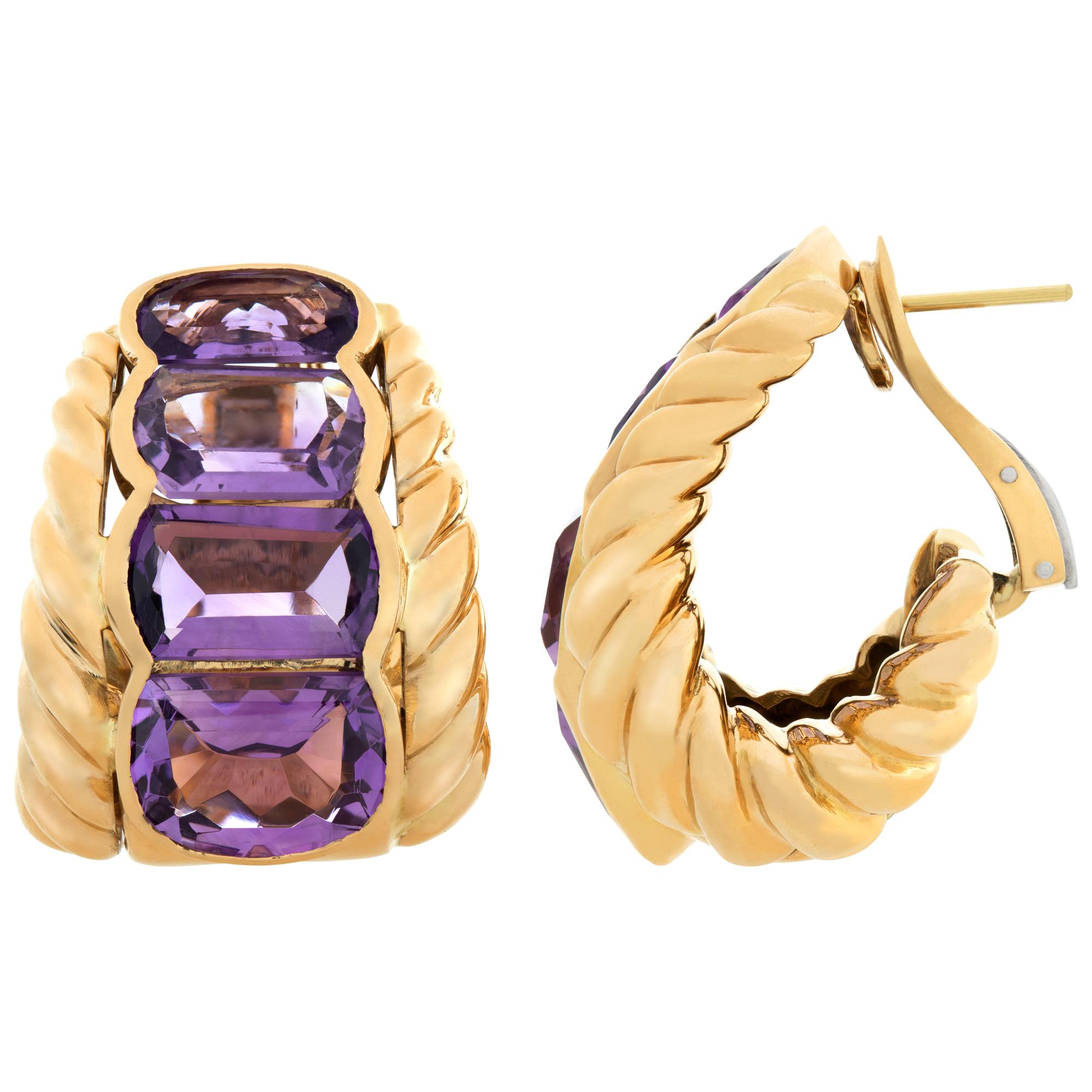 Half wide hoops with over 28 carats graduating emerald cut Amethyst set in 18K yellow gold. Omega clip post. 40mm high x 25 mm wide.
