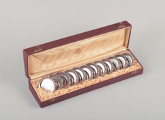 Hallberg, Royal Swedish Court Supplier. Twelve glass coasters in silver.