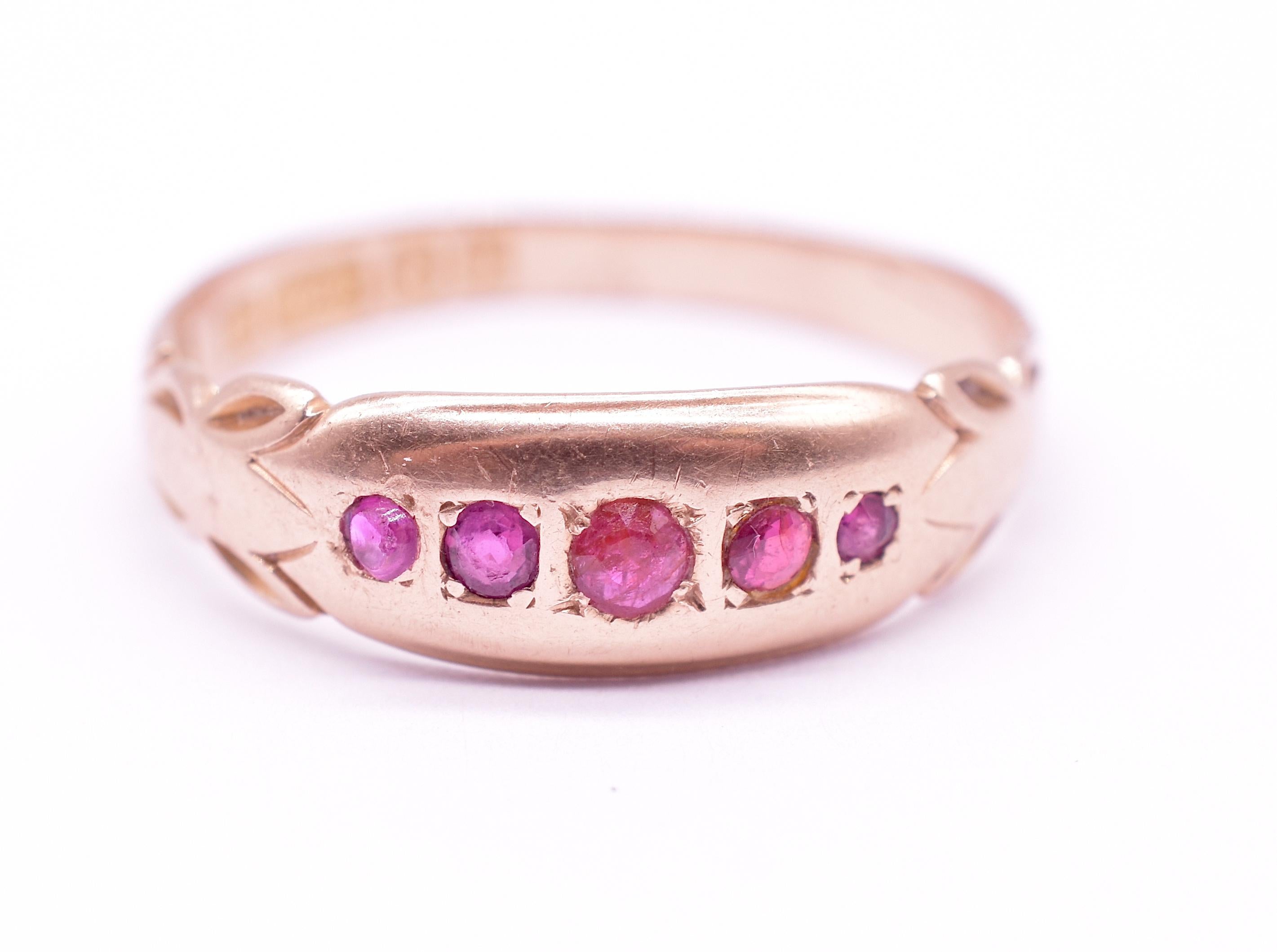 Our 15K Edwardian era ruby ring has 5 round rubies mounted securely along the ring face in carved square mounts. The band has a carved leaf 