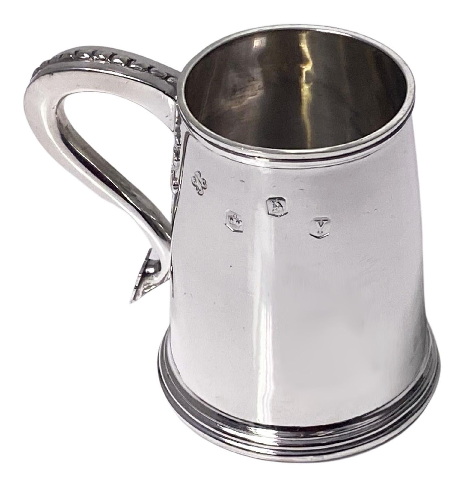 Hallmarked Britannia standard (.950) silver small tankard cup, Sheffield 1966 BSC. Tapered plain form, the handle with cut card and rivet design. Lovely quality and gauge of silver. Measures: Height: 7.1 cm. Diameter of base: 6.50 cm. Breadth: