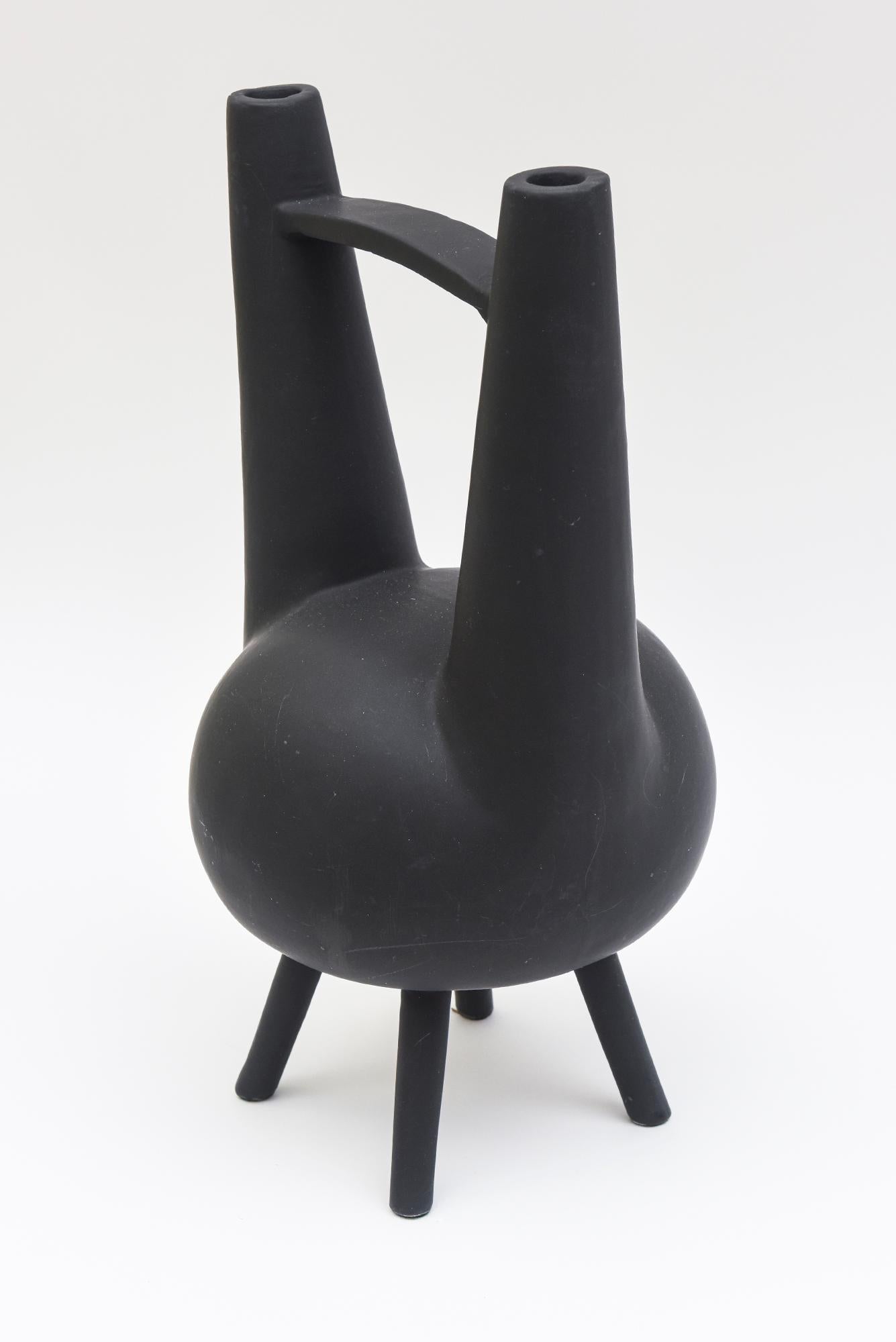 This most unusual Italian hallmarked Pampaloni matt glazed ceramic black abstract vessel or sculpture or object has 4 tripod legs with a bulbous center. It has allusions to a Japanese design meets Italian form. It has been attributed to a design