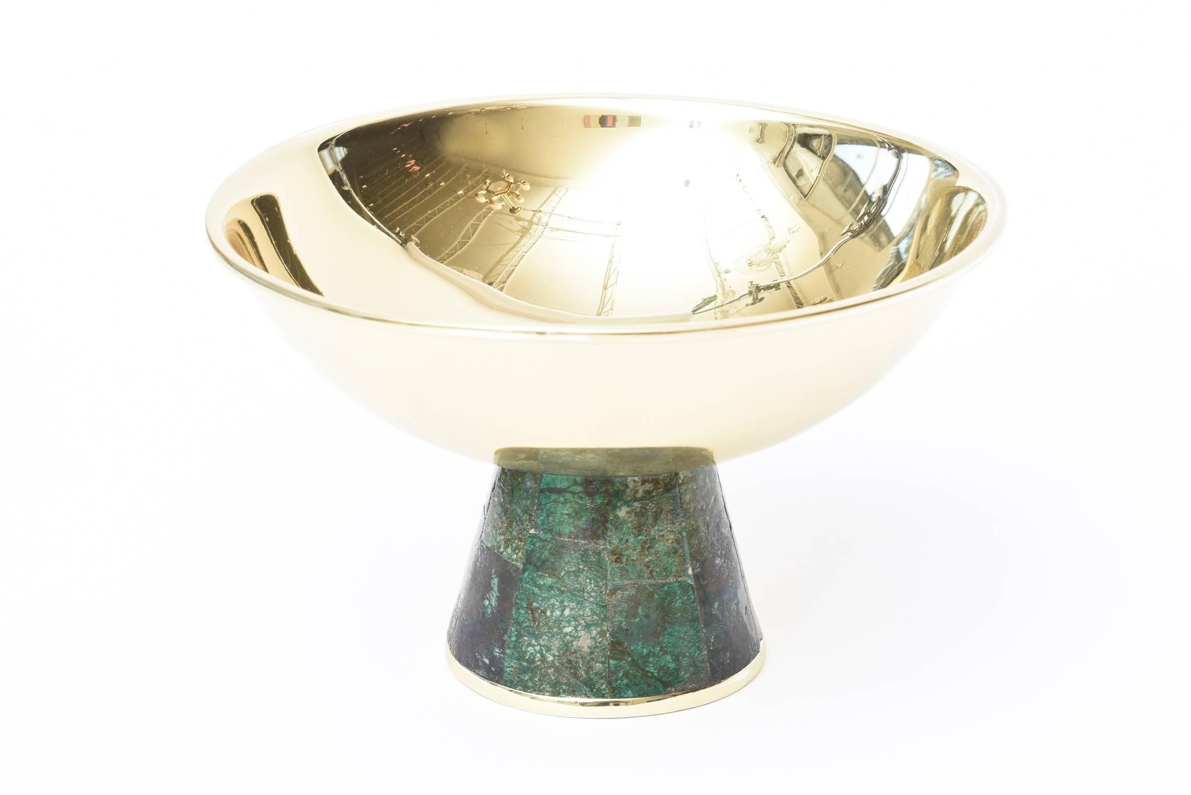 This lovely Mid-Century Modern hallmarked Los Castillo raised tazza bowl is polished brass and the base is sodalite. It is crushed turquoise with other stones from the period. The base also has a brass lip at the bottom. This is a go to bowl that