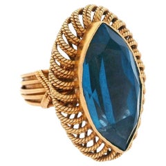 Bague rétro de 1950 poinçonnée en or jaune 18 carats avec topaze bleue