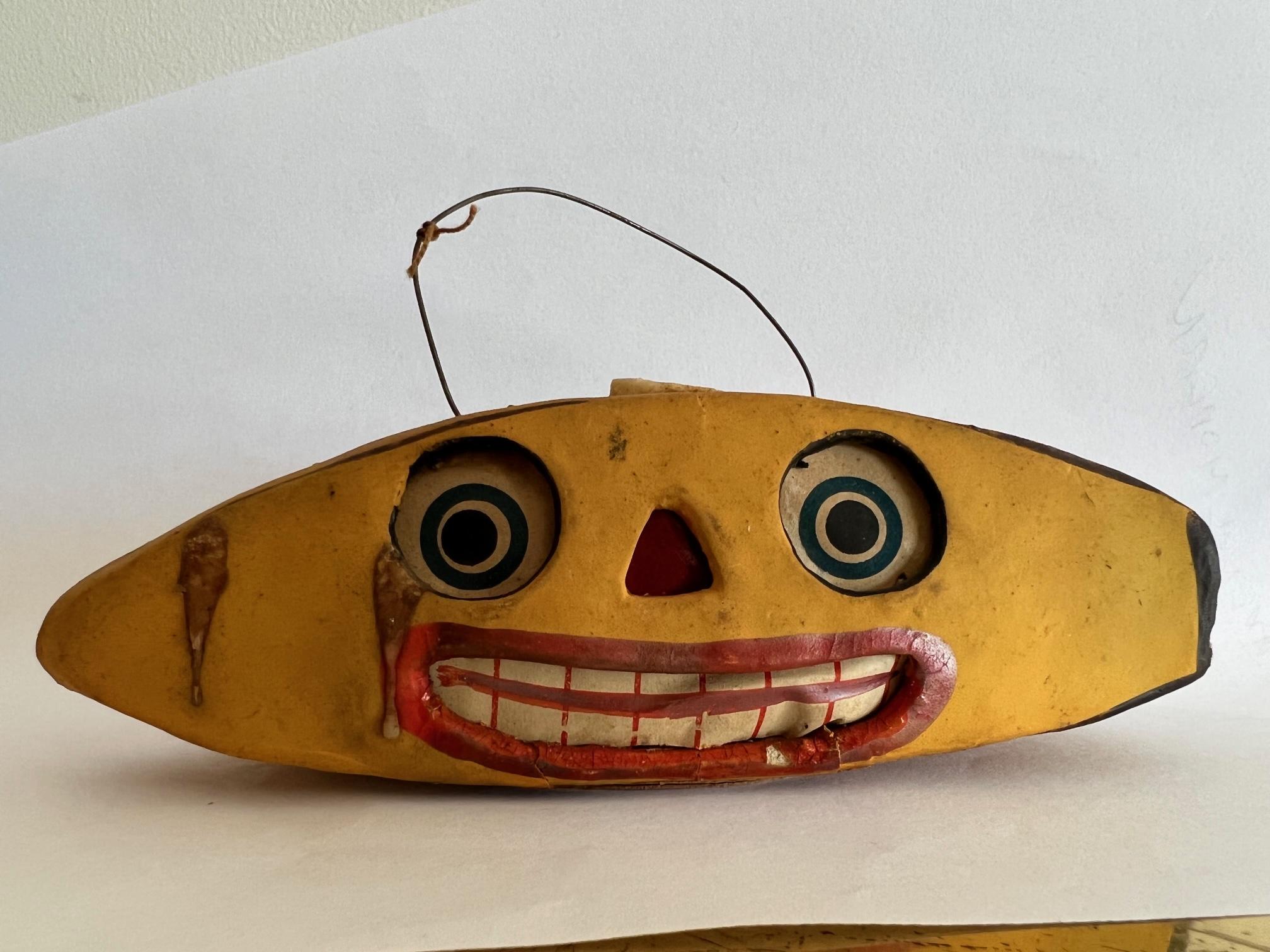 Unusual and rare Halloween lantern as banana face, made in Germany ca' 1930's. Papermache with original candle inside meant to be hung. Comical and spooky-folk art.