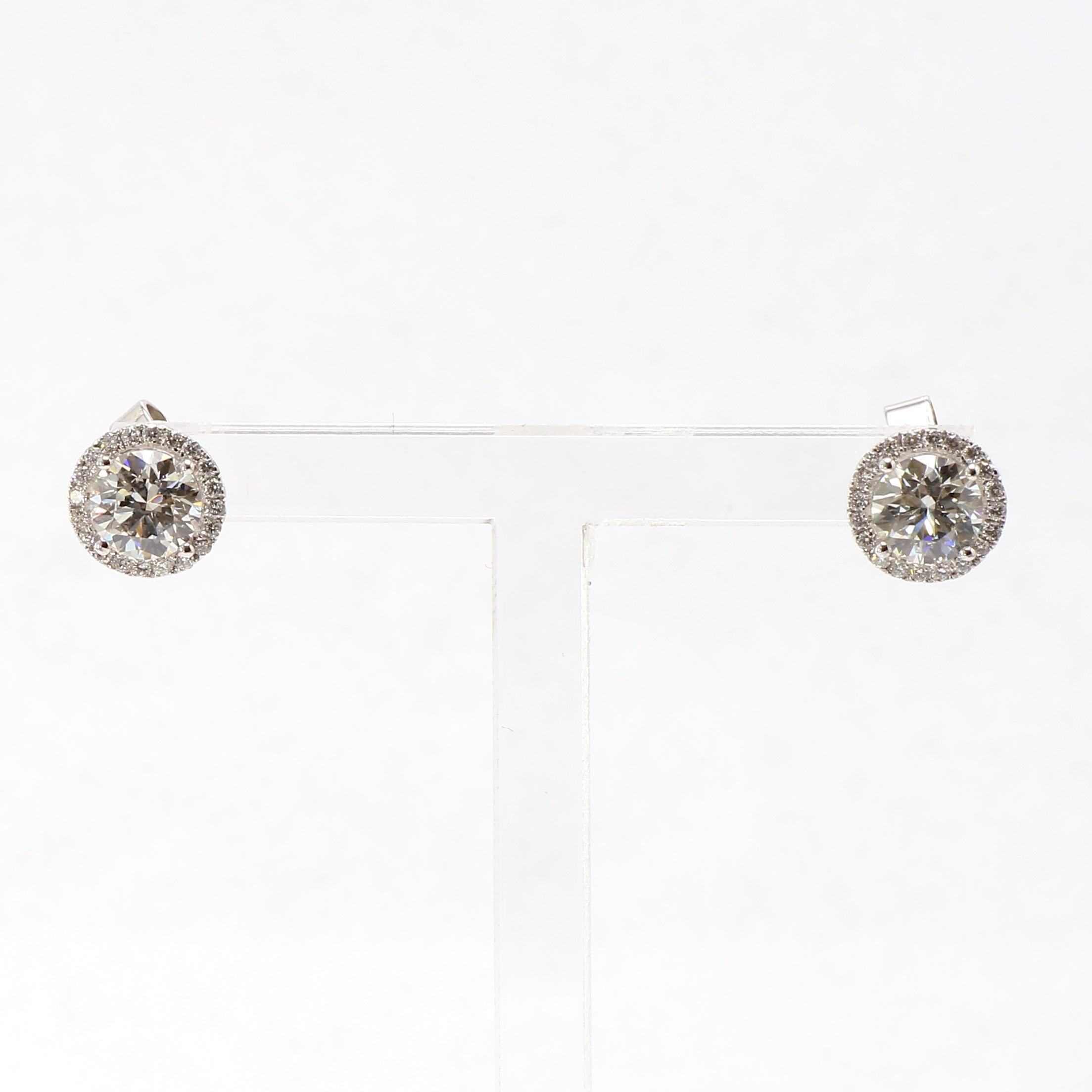 Beautifully handcrafted pair of Diamond Stud Earrings, Halo Style set in 18K White Gold
Round Brilliant Cut White Diamonds totaling 1.41ct H Color, VS1 Clarity, Cut and polish by Shimansy. and surrounded by Round Brilliant Cut White Diamonds
