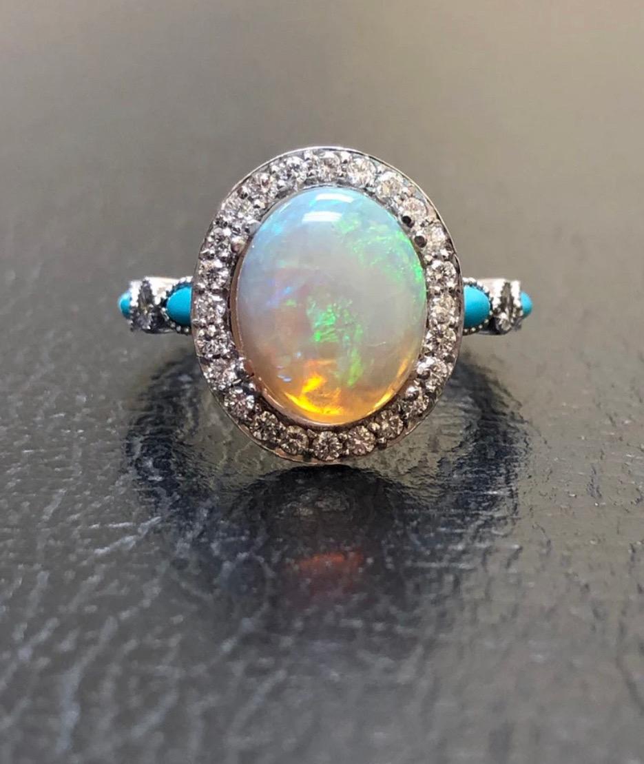 DeKara Designs Collection

Metal- 90% Platinum, 10% Iridium.

Stones- Center Features an Oval Fiery Australian Opal Cabochon Cut 12 x 10 MM 2.20-2.50 Carats, Four Marquise Turquoise, Two Round Opals, 30 Round Diamonds F-G Color VS2 Clarity, 0.40