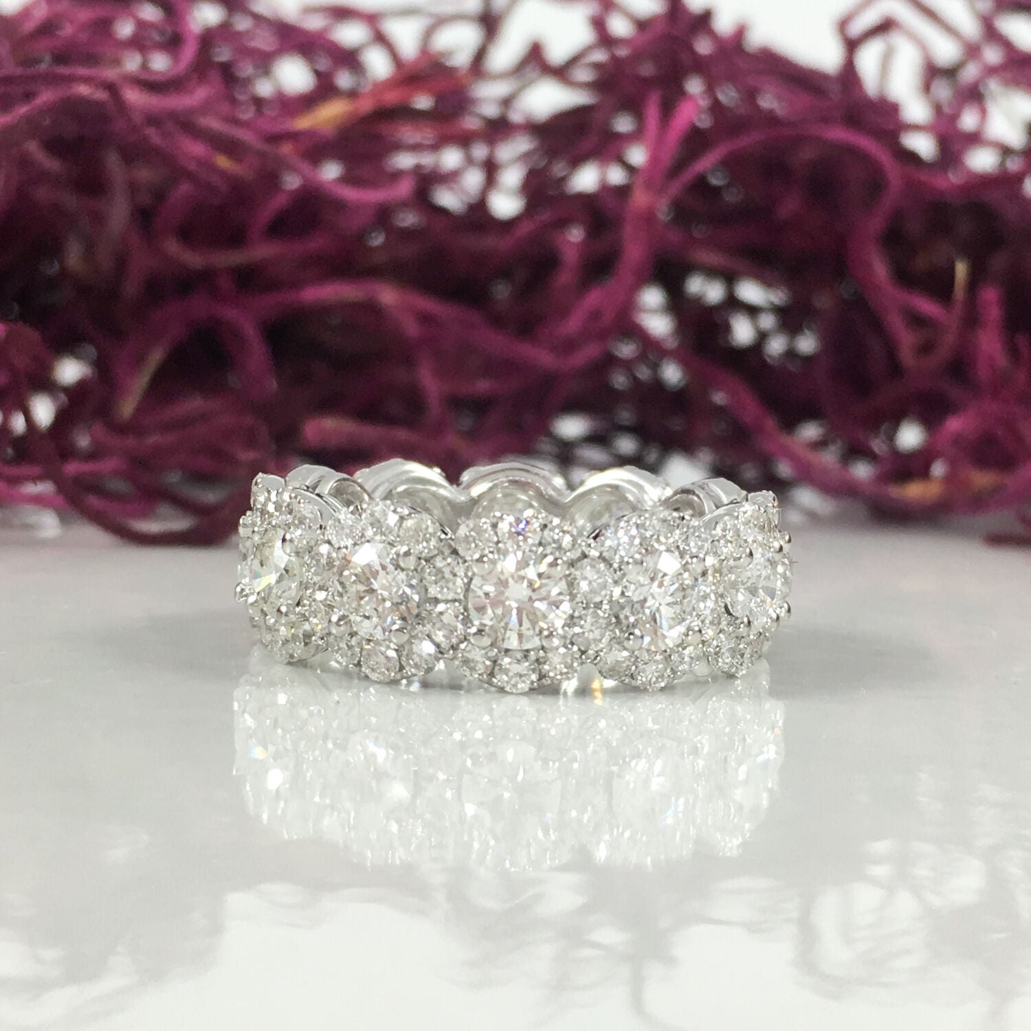 12 center diamonds (0.17 CT / 3.6mm each) and 96 side diamonds (0.02 CT / 1.8mm each) halo eternity engagement ring in 18k white gold. The ring is designed and handmade locally in Los Angeles by Sage Designs L.A. using earth-mined and conflict free