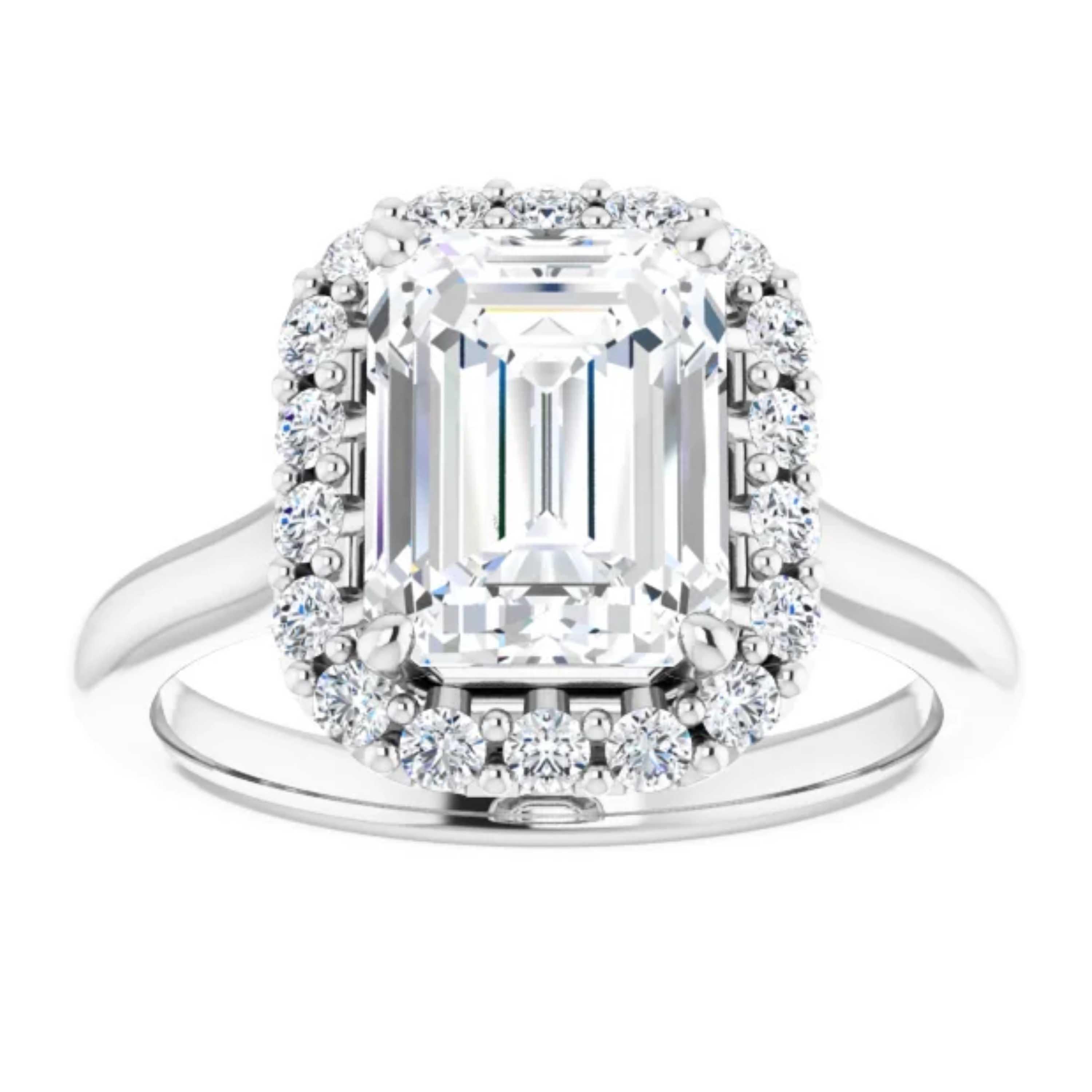 An emerald cut GIA certified diamond is amplified by a halo of fiery white diamonds on this simple yet unique engagement ring. Showcasing a plain 14k white gold shank, this beautiful wedding ring is a transcendent reminder of your everlasting love,