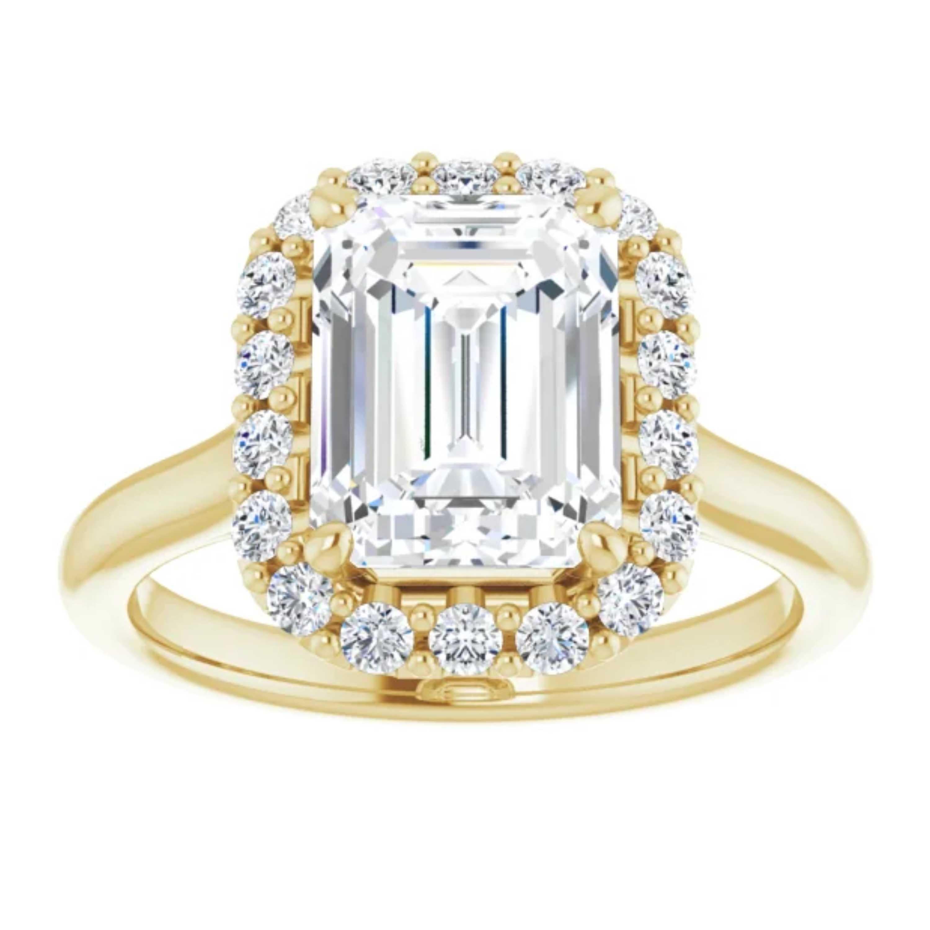 This simple yet unique engagement ring features a halo of shimmering white diamonds encircling the halo and amplifying the GIA certified center emerald cut diamond. Handcrafted in 14k white gold, this wedding ring is reminiscent of your eternal