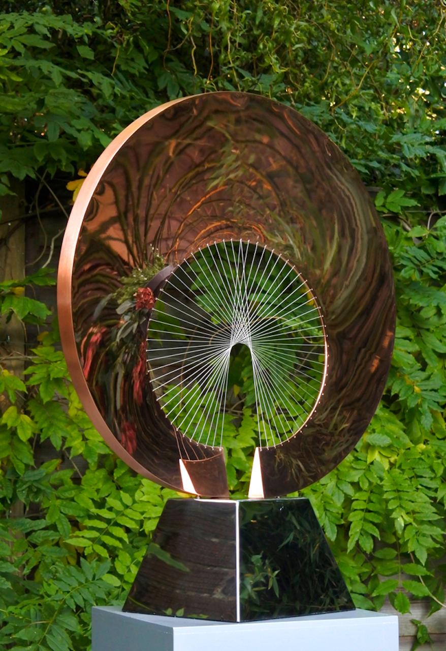 'Halo' sculpture in copper by British sculptor Thomas Joynes. The artist designed the original Halo in mirror-polished steel for the walled Spider's Garden of Hoveton Hall in Norfolk. His concept for the commission was to create a large, mirrored