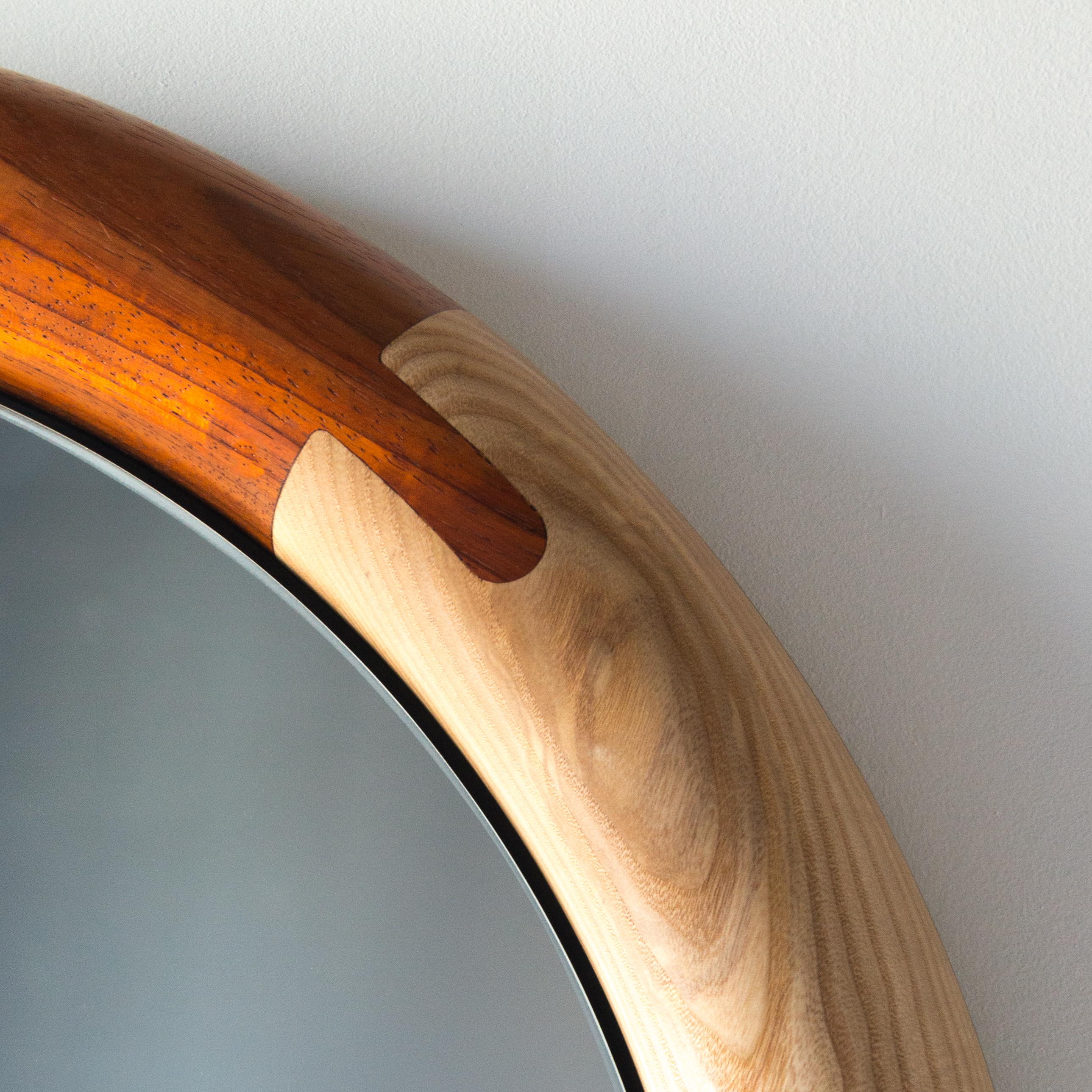 The Halo Round Mirror is composed of a richly colored range of wood species and featuring detailed joinery and sensuous curves and symetries. Available in our stock varieties of wood species to ship now, or available for custom orders.  