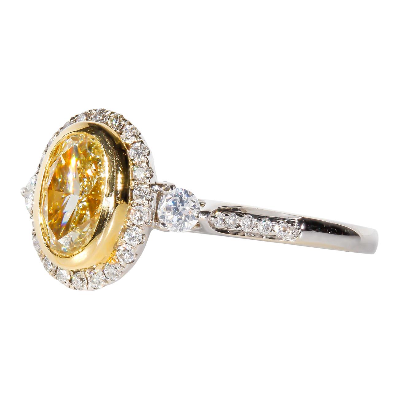 Halo Ring in 18K WG with Fancy Light Yellow Oval Diamond Center. D1.36ct.t.w. For Sale 1
