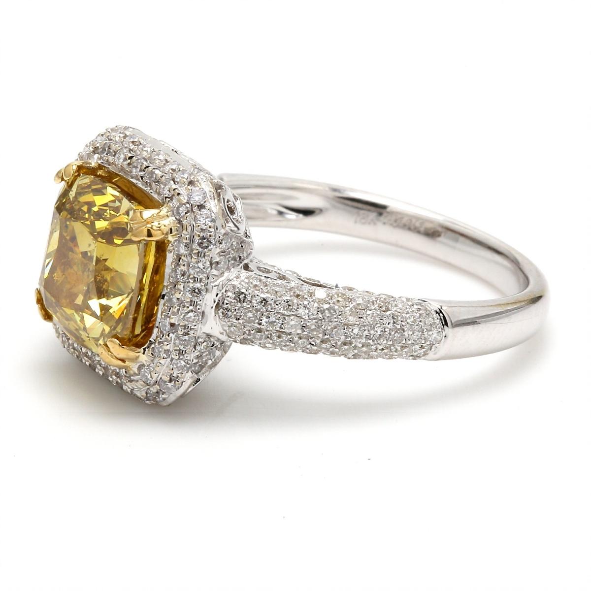 Halo ring in 18K two-tone with GIA certified Fancy Deep Brownish Yellow/SI2 cushion cut center and French pave set round diamonds.  D3.59ct.t.w.  (Center 2.83ct.)  Size 6.25