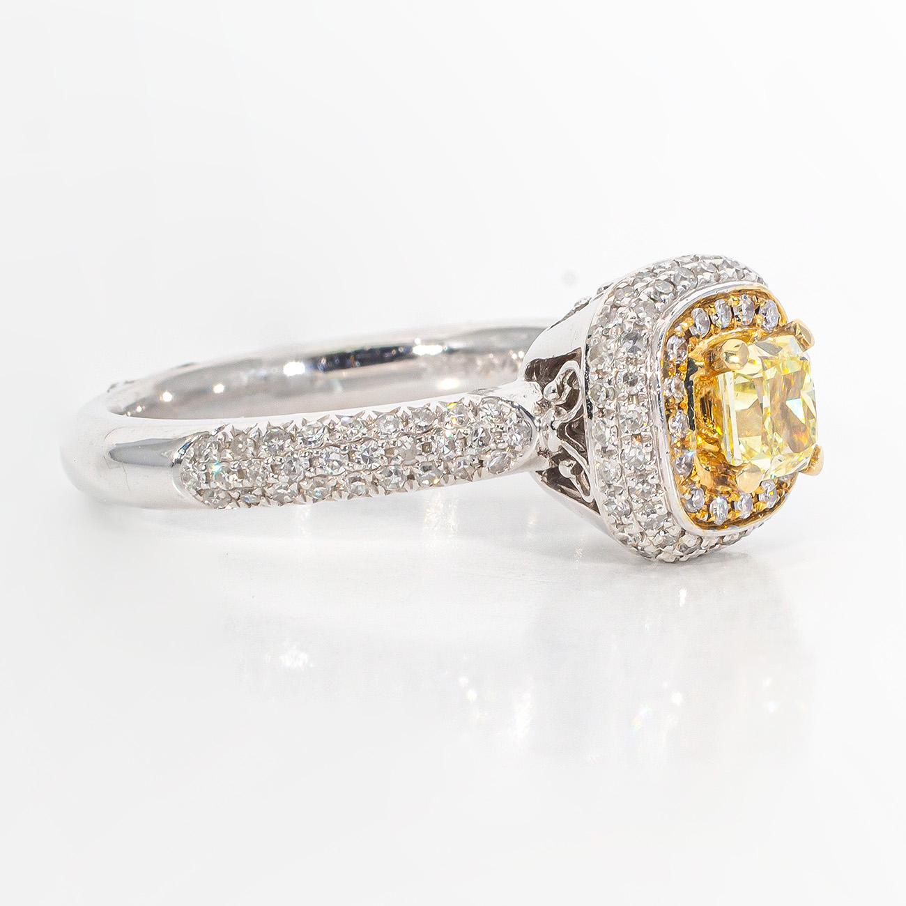 Halo ring in 14K two-tone with French pave set rounds around a 4-prong set Fancy Yellow cushion cut diamond center.  D0.99ct.t.w.  (Center 0.52ct.)  Size 7
