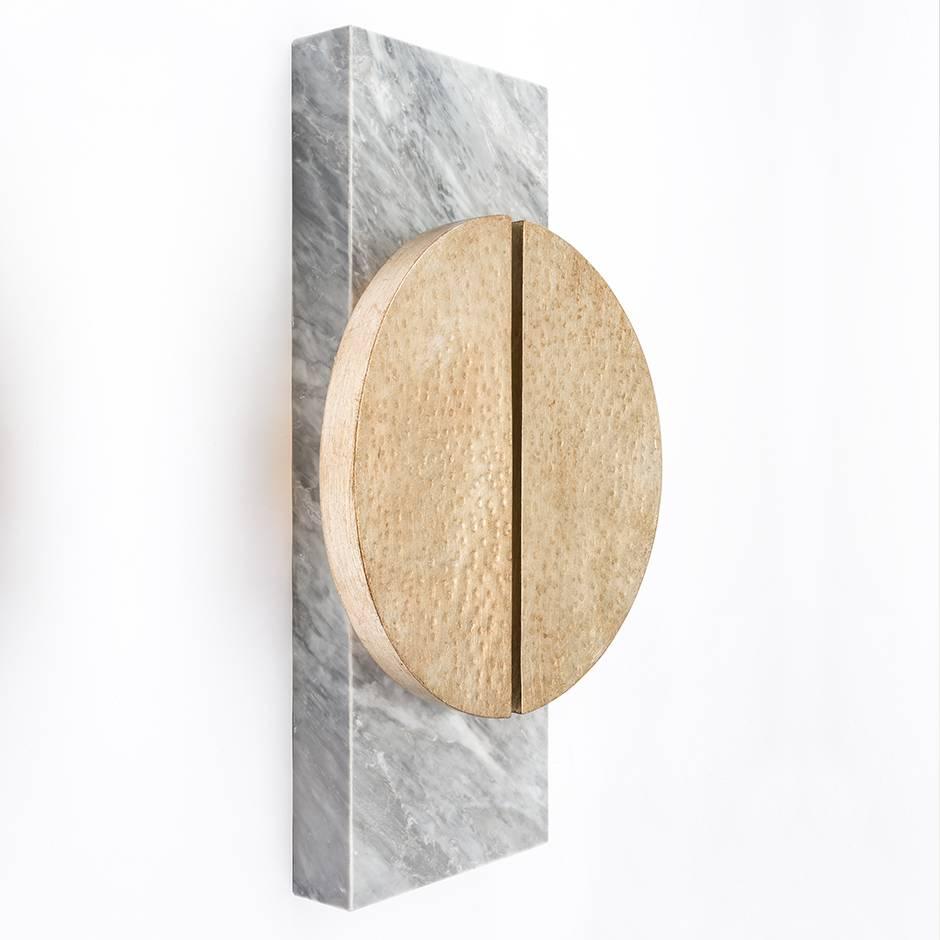 HALO SCONCE - Modern Hand-Forged Leafing Sconce on a Carrara Marble Plate

The Halo Sconce is a beautiful and elegant wall sconce that is sure to add a touch of sophistication to any space. Hand-forged with leafing over iron, this sconce is designed