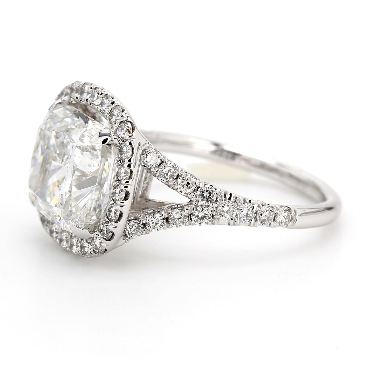 Halo split shank ring in 18K WG with U-prong set rounds around a 4-prong set GIA certified H/VS2 cushion cut diamond center.  D5.66ct.t.w.  (Center 4.83ct.)  Size 6.5