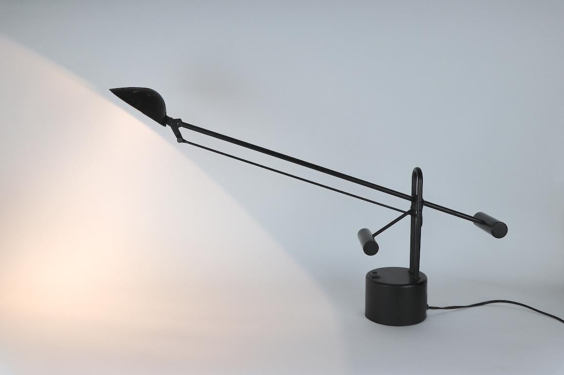 Nice adjustable desk lamp circa 1980s. This example is in original, clean and working condition, showing only light cosmetic wear, normal and consistent with age. Hood shade has a slight scratch, as shown. Base 3 inch height x 4.5 inch diameter.