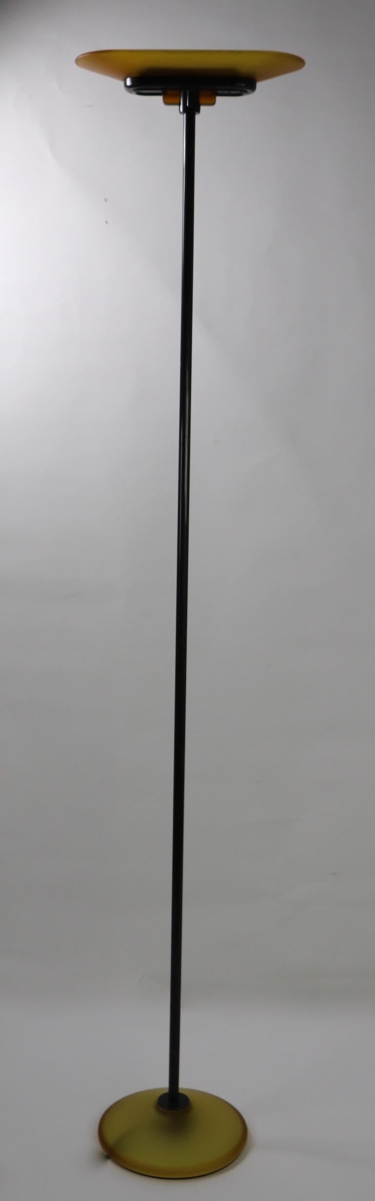 Nice example of the Classic Jill floor lamp designed by Santiago Miranda for Arteluce, circa 1980s halogen up light torchiere. This model has an amber glass shade, and base, with black metal vertical rod. It has an on line on off switch along with