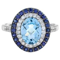 Bague de style Art déco en or 18 carats avec topaze bleue ovale, saphirs et diamants