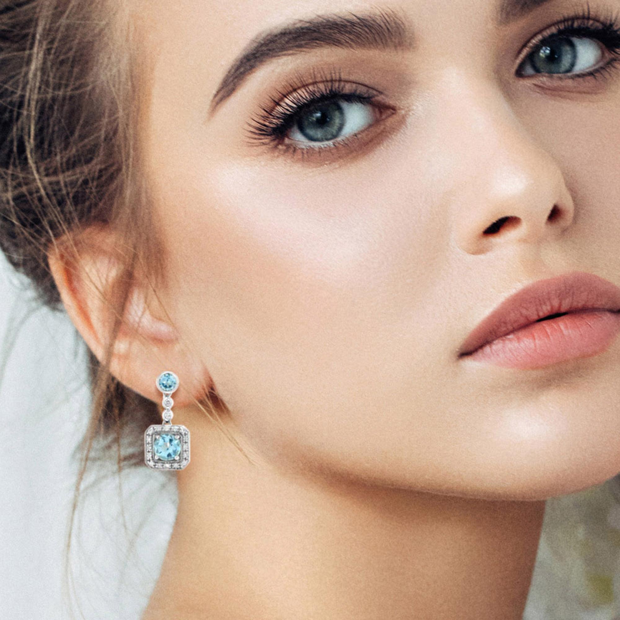 Dainty round cut sky blue topaz are framed by tiny diamond on square frame in 14k white gold. Pretty earrings for bridesmaids and great for brides looking for square shape earrings and need it simple. The earrings can be used on every occasion and