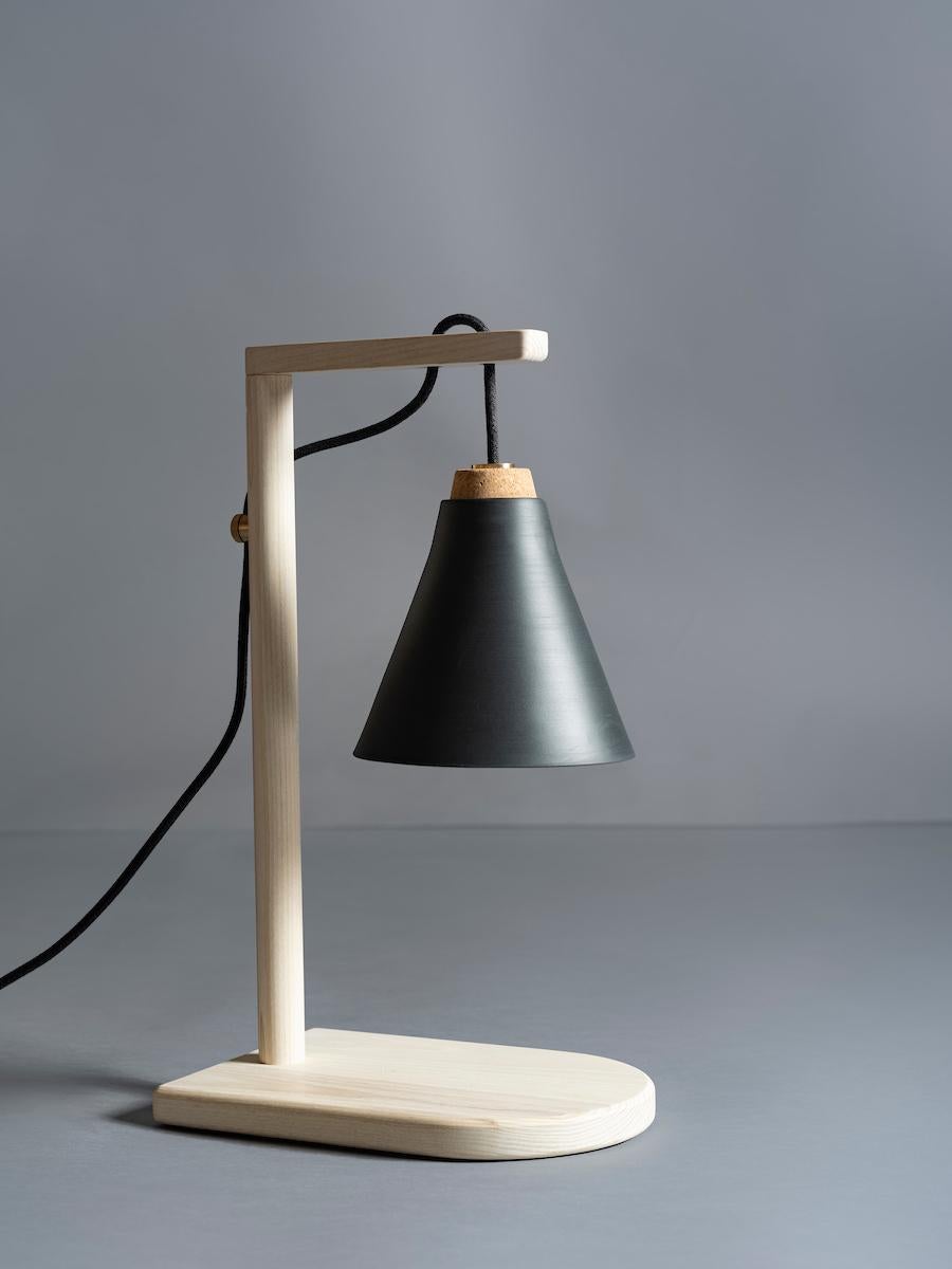 As shown:
Solid ash and walnut with cork hung porcelain shade and brass cord stay..
Bleached or oil finish.
Dimensions: 20” H x 8” W x 12” D
Shade offered in white, graphite and camel porcelain.
Offered in natural or bleached ash and natural