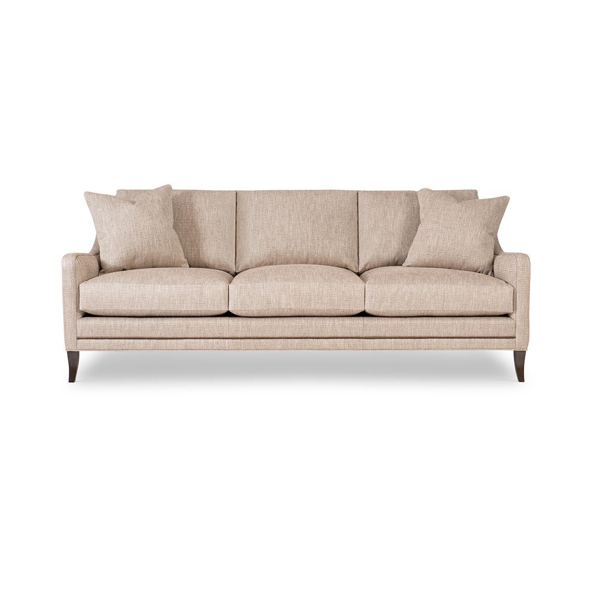 With three loose back cushions and boxed cushion seats, with low profile arms, raised on flared tapered legs, with framed trimwork to the sides.

Proudly made in the USA, each piece boasts traditional 8-way hand-tied construction and toxin-free,