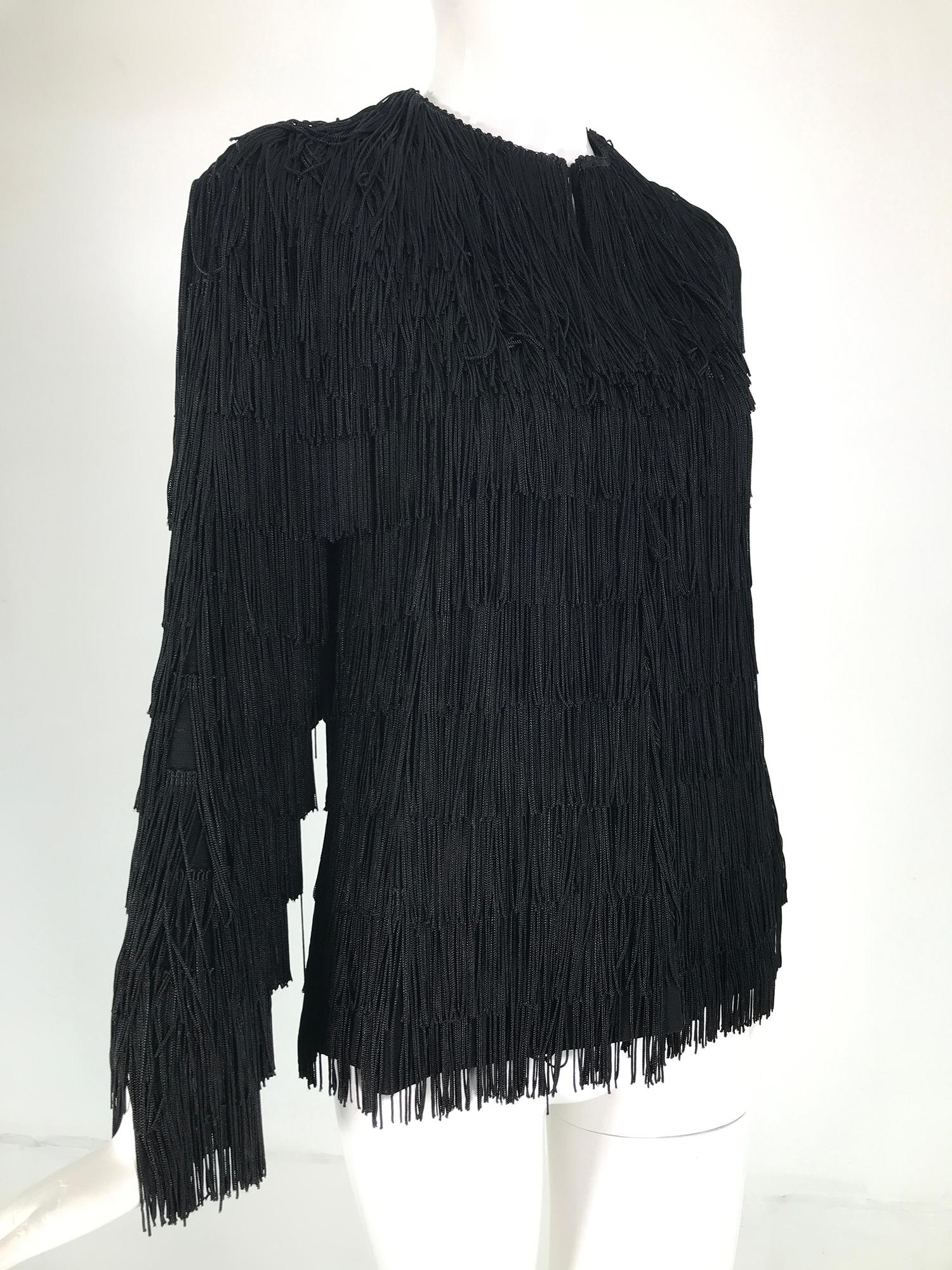 Halston 1970s black fringe jacket. Black jersey is covered in rows of long black fringe. The jacket is unlined but it is finished inside, closes at the front with hidden hook & eyes. Fits like a size 2.
      In excellent wearable condition.  All