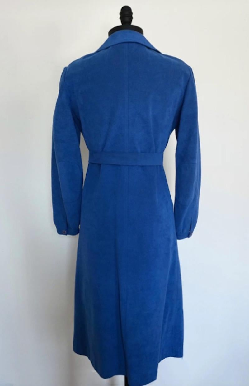 Its a Halston! Halston 1970's Blue Ultrasuede Coat Dress in electric blue. The Utrasuede collection is one of Halston's most significant. The Halston Ultrasuede was a 1970s staple, jumpstarting Halston's thriving career in fashion. 

Shoulders 18