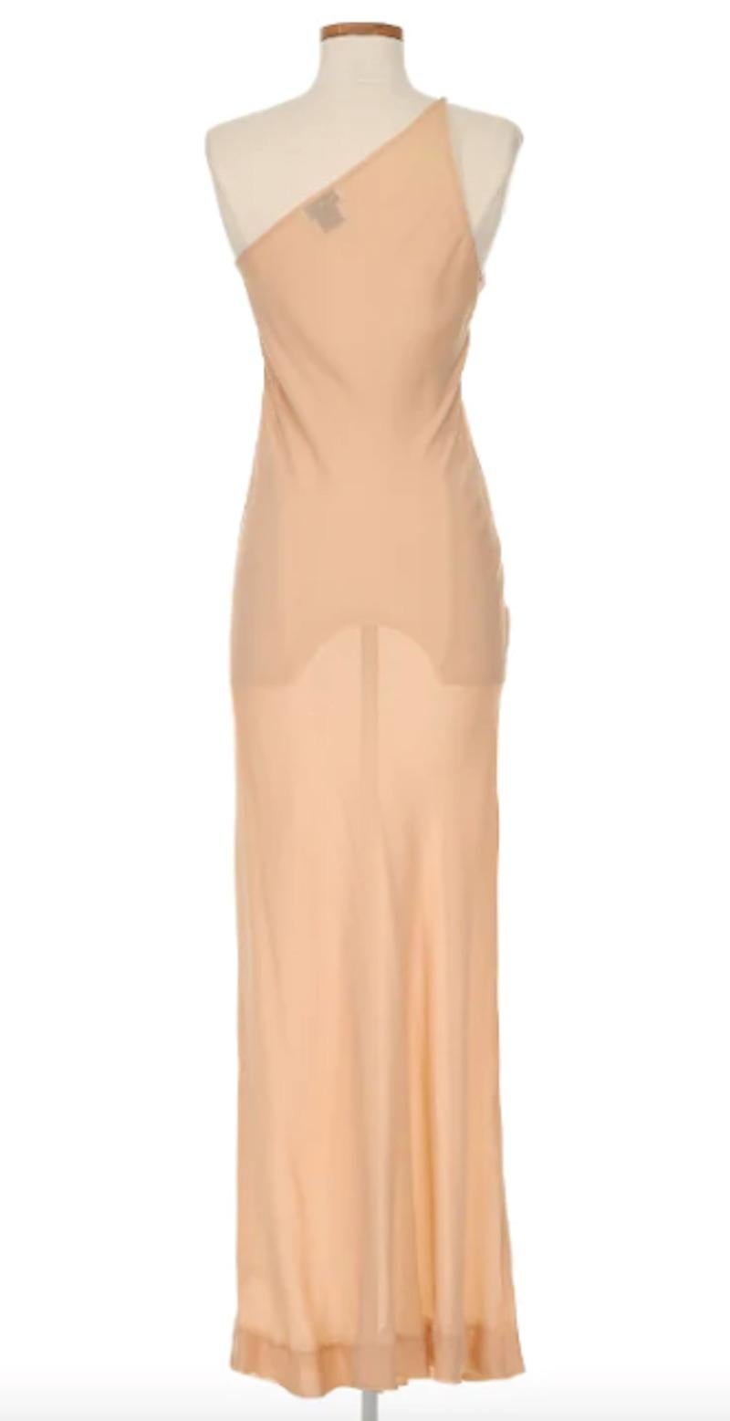 Halston 1970's Haute Couture Nude One Shoulder Dress. This dress exudes timeless elegance - in a sheer nude silhouette and jeweled embellishments along the neckline, this piece is truly memorable, and a remarkable legacy of Halston's craftsmanship.